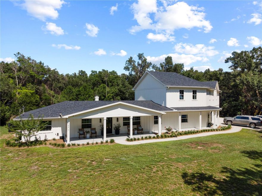 16217 Lake Johns Circle is a rare modern farmhouse retreat where luxury, craftsmanship, and family-centered design come together in extraordinary fashion.

Positioned on a quiet cul-de-sac of only 15 homes with no HOA, this fully reimagined Winter Garden residence offers front-porch views toward Johns Lake and backs to protected green space, creating a setting that feels private, peaceful, and deeply connected to nature.
Completed in 2025, the home underwent an extensive renovation and expansion with remarkable attention to detail and quality. Unlike typical luxury renovations, much of the craftsmanship was personally completed by the homeowners themselves-resulting in a residence that feels intentionally built rather than simply remodeled.

Inside, the home unfolds with warm modern farmhouse design, engineered hardwood flooring throughout, soaring ceilings, custom millwork, curated lighting, and expansive gathering spaces designed for both everyday living and elevated entertaining.

The chef's kitchen serves as the architectural centerpiece of the home, featuring professional-grade appliances, custom cabinetry, quartz surfaces, a hidden butler's pantry, beverage station, and an oversized gathering island wrapped in authentic character and texture.

The floorplan was thoughtfully designed to accommodate multigenerational living and large gatherings with uncommon flexibility. Unique design moments include custom built-in bunk spaces, a secondary bedroom designed with three built-in beds, and a truly exceptional owner's retreat featuring vaulted ceilings, a private sitting area, spa-inspired bath, oversized custom closet room, and peaceful views toward Johns Lake.

The upstairs loft creates an additional lifestyle space ideal for media, gaming, reading, or relaxation, while the nearly 1,500-square-foot insulated garage/workshop offers incredible versatility for vehicles, boats, hobbies, fitness, or storage.
Major infrastructure improvements completed in 2025 include a new roof, new HVAC systems, new windows, new plumbing, tankless water heater, septic system, and extensive mechanical upgrades.

Located minutes from Downtown Winter Garden, Oakland, the West Orange Trail, and major roadways, this is a rare opportunity to own a highly customized modern farmhouse retreat in one of Central Florida's most desirable lifestyle corridors.