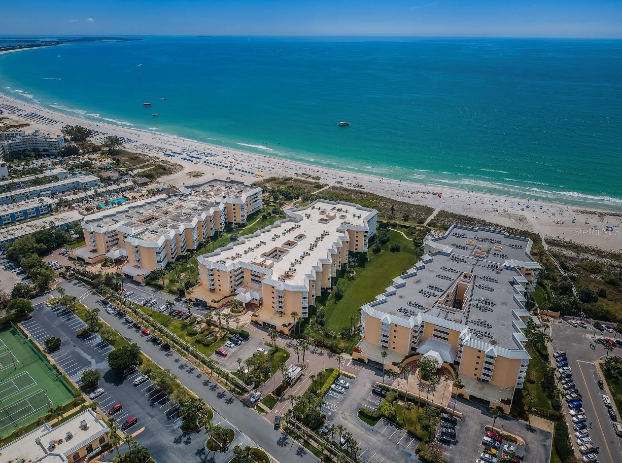 Rarely available corner unit with direct Gulf views and the largest floor plan in Silver Sands—this spacious 3-bedroom, 2.5-bath condo offers the ultimate in coastal living. A sprawling wraparound balcony invites you to enjoy stunning sunsets and sea breezes from multiple vantage points, with plenty of room to dine, lounge, and entertain outdoors. Inside, a generous living room opens seamlessly to the balcony and offers breathtaking water views. The spacious kitchen is well-connected, with sliding doors to the balcony for easy access while entertaining. Wake up to the Gulf in your primary suite, complete with dual walk-in closets and a spa-style bath featuring double vanities, a soaking tub, and separate shower. At the opposite end of the unit, two additional bedrooms and a bathroom provide privacy for guests or family. One has its own private balcony with water views and a storage closet. A dedicated laundry room and powder bath round out the thoughtful floor plan. Silver Sands is a gated beachfront community offering resort-style amenities: two beachfront pools (heated in winter, cooled in summer), hot tubs, a private walkway to St. Pete Beach, clubhouse with a fitness center, billiards room, large gathering space and catering kitchen, outdoor patio seating, six brand-new pickleball courts, and two full-size tennis courts. This isn’t just a condo—it’s a lifestyle. Ideally located at in the heart of St. Pete Beach, you're moments from local favorites, vibrant beach bars, casual dining, boutique shops, and just a short drive to downtown St. Pete’s arts and restaurant scene. Here, every day feels like vacation.