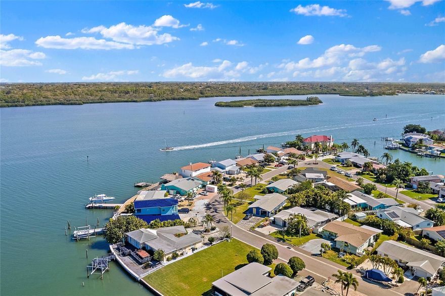 MOVE IN READY!  Completely remodeled by a local licensed GC! This coastal dream property with a high quality METAL ROOF offers one of the best intracoastal water views in Pinellas County! Coastal luxury awaits in this freshly remodeled 3 bedroom, 3 bathroom, 2,310 sq. ft. home directly on the Intracoastal Waterway.  In 2019 new HVAC systems and new high quality IMPACT WINDOWS and DOORS were installed. Relax in the great room while enjoying amazing open water views through a wall of impact glass sliding doors. Enjoy gourmet dining looking out to the Intracoastal in your spacious dining area. The family chef will not be disappointed in the open-concept kitchen with induction cooktop, QUARTZ counters, large island and brand new appliances. The first floor master bedroom suite provides seclusion and tranquility with a sliding glass door overlooking the water, ample closets and en suite bathroom with beautiful cabinetry and frameless glass shower enclosure.  Take the stairs or ELEVATOR to the 2nd floor which features a cozy family room, two large guest bedrooms with open water views and a guest bathroom. The backyard oasis has an expansive paver patio and private deep-water dock perfect for fishing, water sports and boating. With 60’ of WATER FRONTAGE, the yard has plenty of room to put in a pool and still have space for an outdoor entertaining area. Store your beach and water toys in the impact rated shed.  Just minutes from the beach and a short boat ride to the Gulf, this home will fulfill all of your waterfront dreams.