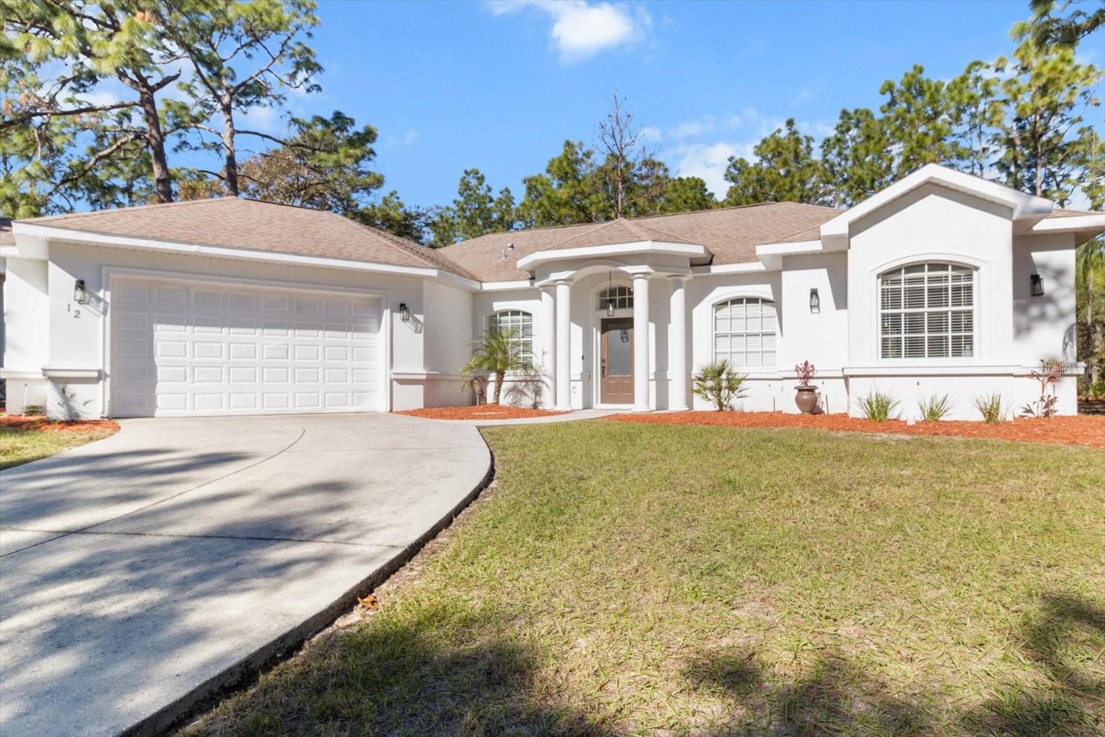 This spacious and inviting three-bedroom, plus den, two-bath home is located on a peaceful cul-de-sac in Sugarmill Woods. Featuring an open floor plan that is both light and bright, it offers a touch of luxury with tray ceilings and a master suite complete with his and hers walk-in closets, as well as a large bath with a garden tub and walk-in shower. The home boasts stylish luxury vinyl flooring and ceiling fans throughout for comfort. The kitchen is great for entertaining, with a breakfast room, stainless steel appliances, and granite countertops, along with a formal dining area adjacent to it. The large in-home laundry room is conveniently located near the two-plus car garage. Enjoy easy access to local amenities including shopping, medical services, restaurants, golf, boating, and fishing in the nearby rivers and Gulf.
