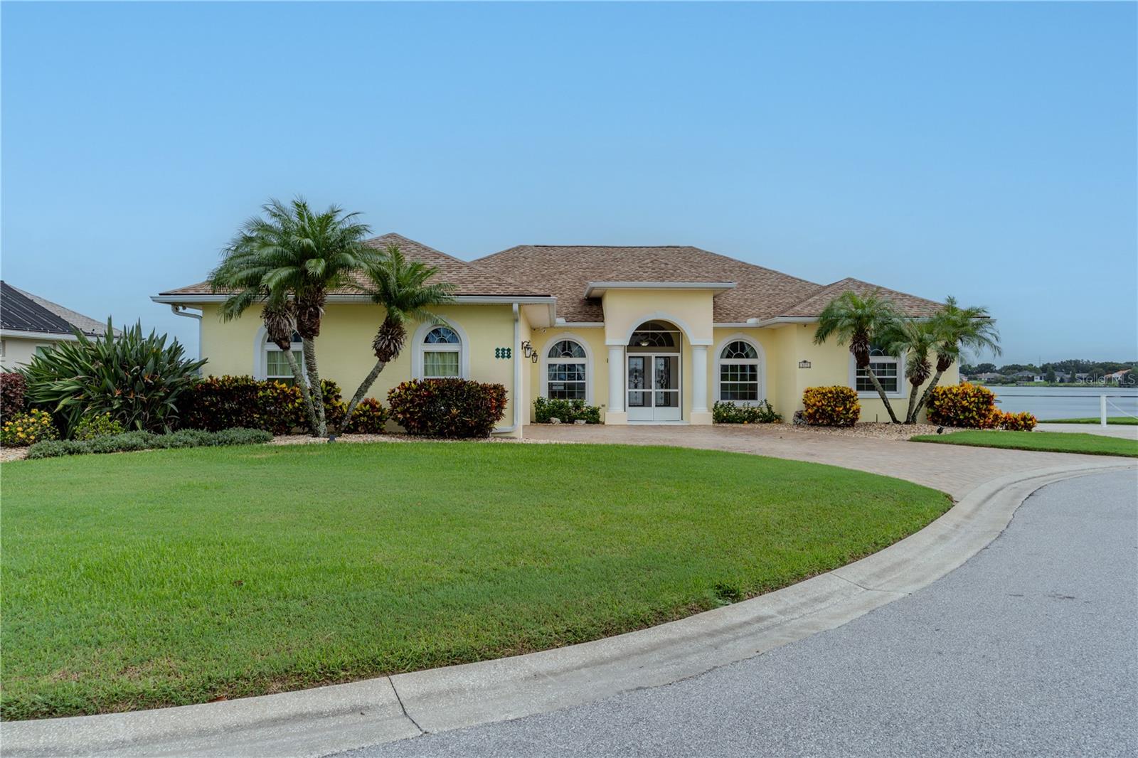 Welcome to your perfect sanctuary in the heart of Central Florida! With a freshly repainted exterior, this one-level home offers rare and breathtaking lake views and is ideally located in a desirable cul-de-sac. With 4 spacious bedrooms, 2.5 bathrooms, and an impressive range of high-end upgrades, this residence seamlessly combines comfort, style, and convenience. Upon entering, you’ll immediately notice the open, flowing floor plan, accentuated by soaring 10-foot ceilings and ceramic tile flooring throughout most of the home. Thoughtfully updated in 2021 with double-pane storm windows, the home ensures both energy efficiency and serene tranquility. The expansive, open kitchen, featuring stainless steel appliances, quartz countertops, an island, a breakfast bar, and a cozy nook with panoramic views of the lake. Whether entertaining guests or enjoying a peaceful evening, the breathtaking lake views from the family room, living room (with elegant triple glass sliding pocket doors), and oversized primary bedroom will leave a lasting impression. Step outside into your personal backyard oasis, where a spacious caged lanai with pavers, private pool, provide the perfect space for both relaxation and entertainment. Beyond the lanai, you’ll find an oversized composite deck ideal for gatherings, leading to your backyard complete with an in-ground fire pit and mature fruit trees. A new seawall, completed in 2023, offers protection from storms and safeguards the yard. A private dock, complete with mooring whips for boat security and a dedicated fishing area, further enhances the outdoor experience. Additionally, a private boat pad on the side of the home provides convenient storage for your boat when it’s not on the lake. The primary bedroom is a true retreat, featuring a spacious ensuite bathroom with dual sinks, vanities, and a French shower. Three additional well-appointed bedrooms, a large laundry room, and a dedicated formal dining area complete the home’s exceptional layout. This home is also designed with remarkable energy efficiency in mind, featuring a 14.4KW REC/Enphase solar system paired with a 26.6KW battery backup. For over two years, the system has kept electric bills minimal (just a monthly connection fee) and even generates excess power, which is sent back to the grid to help offset the connection costs. With the battery backup, the home’ key areas remains fully operational during power outages, including the ability to run the entire air conditioning system. Additional peace of mind comes from the newly installed automated hurricane shutters on the lakefront windows, a screened front entryway, and a screened lanai cage. Enjoy further savings with a Wi-Fi-enabled irrigation system and pool pump, while Z-wave enabled switches throughout the home allow for easy automation and voice control for lights, fans, and the thermostat. For security, Ring cameras and a closed-circuit surveillance system monitor the home, in addition to ADT security. A whole-house water filtration system ensures clean, pure water, and cable or fiber internet is available. Pest prevention is also taken care of with Home Team ports on both sides of the home. Other notable upgrades include a new roof (2021), a new AC unit (2020) with a 10-year warranty, and additional energy-efficient features that help save on utilities. Homes like this are rare, so don’t miss your chance to experience this stunning property.