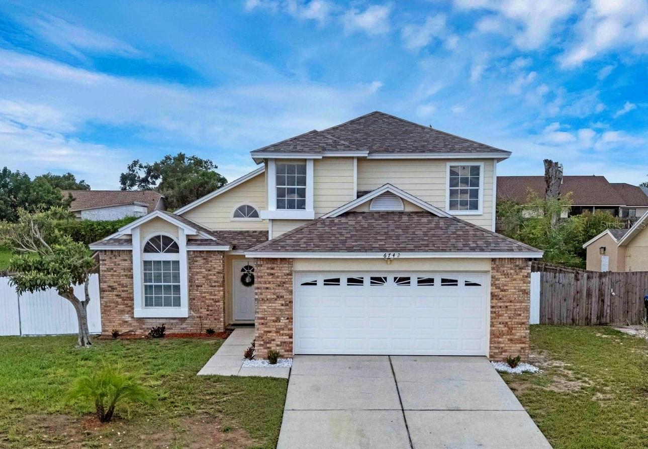 Move-in ready and freshly painted, this beautiful 2-story home offers 4 spacious bedrooms and 2.5 updated baths. Inside, you’ll be greeted by soaring high ceilings, modern updated lighting throughout, and a brand-new chandelier in the dining room that adds a touch of elegance. The open layout flows to a screened-in back porch overlooking a large, fully fenced yard—perfect for entertaining, pets, and play. Enjoy peace of mind with a newer roof and A/C, along with beautifully renovated bathrooms. Conveniently located near shopping, downtown Orlando, major theme parks, and a variety of restaurants—and best of all, no HOA—this home blends style, comfort, and location, making it the perfect place to call your own!