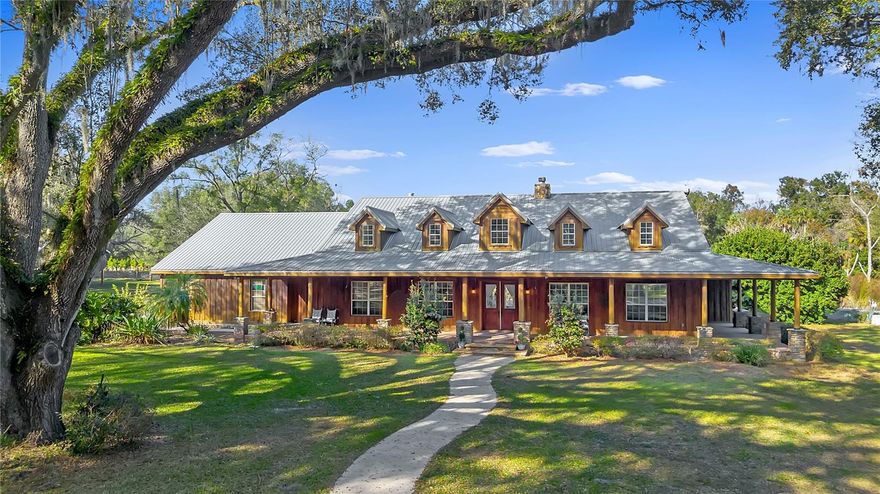 One or more photo(s) has been virtually staged. Welcome to a rare and extraordinary legacy property where time slows, nature surrounds you, and possibilities stretch as far as the eye can see. Set across 66 awe-inspiring acres, this rustic custom estate is enveloped by towering, century-old oak trees, creating a breathtaking canopy of beauty, privacy, and timeless elegance.

This is more than a home—it’s a private sanctuary. A place where horses can run free, cattle can graze peacefully, and beautiful scenic trails invite you to explore your land at sunrise or sunset. Cast a line into your private pond or surrender to total relaxation in the freeform resort-style pool, complete with a dramatic grotto and soothing hot tub—your own secluded oasis under the Florida sky.

The 4-bedroom, 4-bath ranch-style residence was crafted for both grand entertaining and quiet moments of reflection. Multiple expansive porches beckon you to linger, breathe deeply, and take in the serenity that only wide-open land can promise. Gather family and friends for unforgettable celebrations in the main home, then retreat to the separate in-law suite, perfectly suited for guests, extended family, or a private executive office tucked away from the world.

An attached oversized four space garage provides ample space for all your passions—boats, ATVs, equipment, and adventure vehicles—ensuring this estate supports every lifestyle, from refined to rugged.

Though it feels worlds away, convenience remains within reach. A short drive east leads you to Florida’s beautiful beaches, while a trip south brings you to Orlando’s international airport and iconic theme parks.

From its sweeping acreage and majestic landscape to its versatile living spaces and unmatched privacy, this remarkable estate offers limitless potential. If you’ve been searching for a place that speaks to freedom, legacy, and the luxury of space—your dream retreat has arrived.