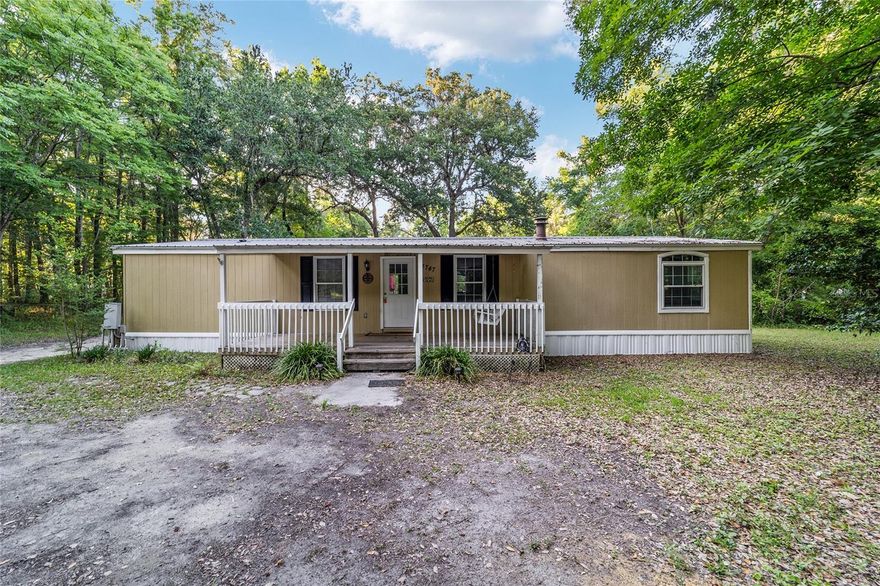 **Cash or VA Loan Only** Serene Private Estate with Custom Workshop! Discover the perfect blend of space and seclusion with this 3-bedroom, 2-bathroom home situated on over 2 acres. Designed for those who value privacy, this property offers a peaceful retreat with plenty of room to move, featuring a welcoming front porch and a back deck perfect for outdoor relaxation. The home includes brand-new AC ductwork for improved climate control and efficiency. A major highlight of the property is the massive detached workshop, which features two bays for car enthusiasts and its own dedicated split AC unit. Additionally, an extra storage shed provides even more room for tools and equipment. Whether you are looking for extra acreage, a secure place for your vehicles, or a quiet location with ample storage, this property delivers. Schedule your showing today to see this property beforee it's gone!