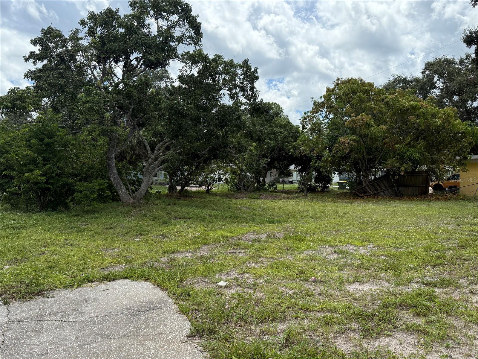 Spacious Corner Lot in the City of Sarasota – Over a Quarter Acre!
No HOA or CDD fees. Build your dream home and enjoy a variety of established fruit trees, including star fruit, sugar apple, lychee, and more. Conveniently located near shopping, dining, parks, and the Legacy Trail. Just 7 miles from the white sands of Lido Beach!