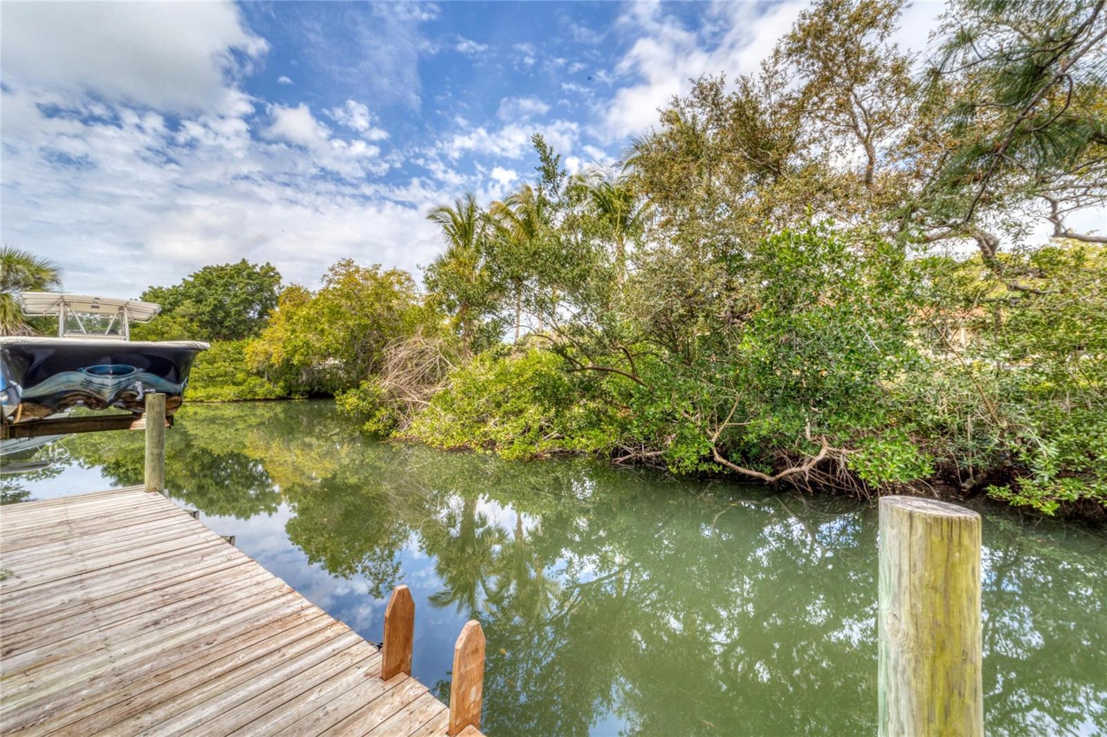Ideal location and an attractive remodeled home in Waterside Acres in Nokomis. Located west of Route 41, along a saltwater boatable canal, and within a mile of the beautiful calm waters of the Gulf of Mexico. Some of the features of this home are the recent updates: new Hurricane Resistant windows and doors in 2022 and a new metal roof and new HVAC system in 2018, plus the kitchen was updated 7 years ago. With these items taken care of, this home is a rare find in today's market. Move in with confidence, knowing that the essential updates have been completed, allowing you to focus on making memories in your new haven. The spacious living room, with large windows and neutral floors, flows into the dining area, plus there’s a family room at the back of the house with sliders to the patio and backyard. Relax in the shade in the comfortable covered lanai or go out back to the large patio where you can enjoy your morning coffee, bask in the sunshine, and dine al-fresco in the private back yard. Or enjoy the canal by relaxing on the long wooden dock. The canal was dredged in 2016 and is boatable. The dock has electric and water to it and there is room for a boat lift to be installed. You can be in the Gulf of Mexico in about 15 minutes by boat. There is one fixed bridge (Albee Rd) with a height of about 8’. Located just a short drive, walk, or bike ride to Nokomis Beach where you can enjoy sun-drenched days, yoga, drum circle, and breathtaking sunsets just moments from your doorstep. There’s two waterfront restaurants within a mile... Pop’s Sunset Grill and Pelican Alley. Located between quaint Venice and bustling Sarasota means you’re removed from major traffic, yet have great options for restaurants, entertainment, beaches, and more. There’s easy access to the Legacy Trail which takes you to downtown Venice or go north to Sarasota. Also, only located a few miles from the new Sarasota Memorial Hospital. This home is a rare find, offering not just a residence but a lifestyle steeped in the laid-back charm of coastal living.