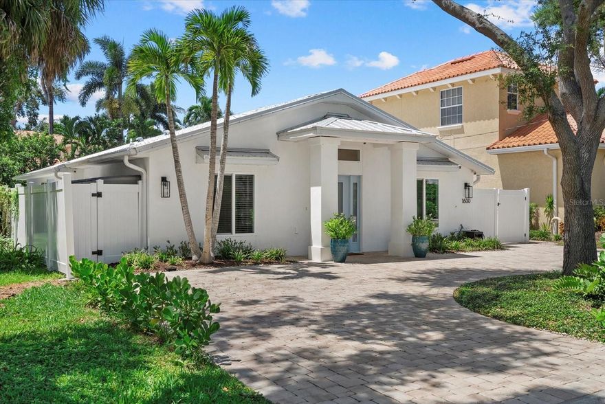 Nestled in one of Sarasota’s most tranquil neighborhoods near Oyster Bay and the Field Club. This custom-built 2021 home blends modern comfort with coastal charm. Every detail was thoughtfully designed to suit the lot, maximize natural light, and create a low-maintenance tropical retreat. Step inside the inviting entryway, and you’re immediately welcomed by an airy, sun-filled interior. The modern porcelain tile flows throughout, making upkeep a breeze and adding to the home’s bright, open feel. The chef-inspired kitchen features sleek Bosch refrigerator and dishwasher and an open layout, connecting effortlessly to the living area so family and friends are always part of the conversation. From the living room, oversized impact-rated sliding glass doors frame the tropical Areca Palms, while the surrounding paver walkways keep everything clean and manicured. The owners suite is a serene sanctuary, and the luxurious master bath is a true showstopper—featuring a deep soaking tub and a sleek modern wet room design typically reserved for far more expensive homes. This home was built to the most current building and storm codes, featuring a metal roof, impact windows, doors, and sliders, and a high efficiency German made electric tankless water heater. Positioned High and dry, firmly outside of any flood zones. The spacious laundry room keeps day-to-day living organized and effortless. Some additional features include spray foam insulation in the attic, a 30 amp circuit for RV or EV vehicle charging and hard wired security cameras for peace of mind. Convenience is one of the location’s best attributes Including Trader Joes, Publix , Local restaurants, boutiques, shops, not to mention the highly desirable Philippi Shores elementary, Sarasota High and so much more. Schedule your personal tour today.