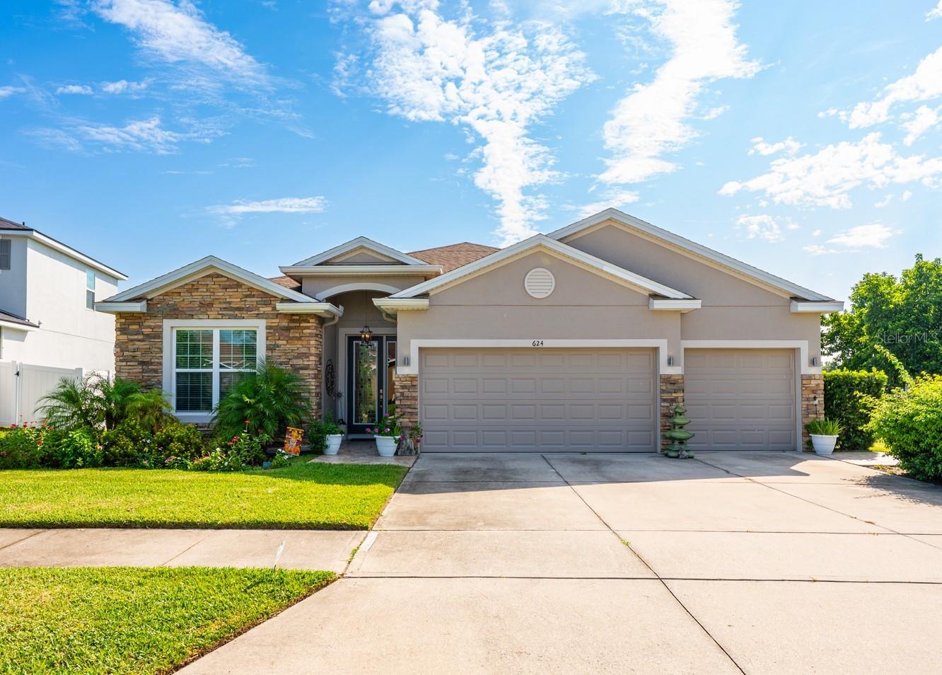 Ask about a lender provided RATE BUY-DOWN CREDIT on this home! ****Welcome to this beautifully designed 4-bedroom, 3-full bath home in the desirable Westwood community of Groveland! With undeniable curb appeal, stacked stone accents, lovely landscaping, and a spacious 3-CAR GARAGE, this home sets the tone for what’s inside – an inviting balance of style, comfort, and functionality. Step into the OPEN CONCEPT layout with a 3-WAY SPLIT floor plan that offers both privacy and convenience. Whether you are hosting friends in the formal dining area or enjoying casual meals in the breakfast nook, the flow of this home makes it ideal for both everyday living and entertaining. Your living area extends outside to a COVERED LANAI and the TILED/SCREENED PATIO, where you will enjoy sweeping views and the peace of having no rear neighbors. Inside, the details matter – TILE FLOORING throughout means low maintenance living, while the crown molding and abundance of natural light bring a refined touch. The heart of the home – the modern kitchen – features an OVERSIZED ISLAND with bar seating, must have STAINLESS STEEL APPLIANCES, plenty of cabinetry, pantry storage, a tiled backsplash, and a mix of recessed and pendant lighting that enhances the bright, welcoming atmosphere. The PRIMARY SUITE is perfectly situated for privacy at the back of the home, also allowing you to take in the serene backyard views. With a tray ceiling finished with crown molding, a fresh take on a modern color palette, DUAL CLOSETS (one is a WALK-IN!), and a generous en-suite bath delivering DUAL/SPLIT VANITIES, a corner soaking tub and large separate shower, it offers the new owner a true retreat! Bedroom four is located next to a full guest bath on the other side of the home – ideal for visitors or in-laws – while bedrooms two and three share a full bath off a separate hallway at the front of the home. The flexible design easily accommodates a home office, overnight guests or multi-generational living. Beyond the home, the Westwood community provides a park and playground, adding to the appeal. The location offers easy access to major roadways, shopping, dining, and the natural beauty of the Clermont Chain of Lakes. While it feels peaceful and private, you are never far from conveniences. Set on a spacious lot, this home combines thoughtful design, desirable upgrades, and an unbeatable setting – and it is ready to welcome its next owner, is that you? Call today to schedule a tour!