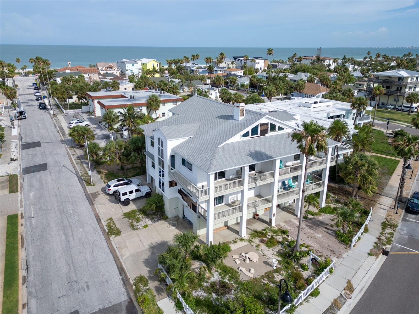 Seller Says - BRING ME ALL OFFERS!!! Rare Opportunity with Coastal Townhomes in the Heart of Historic Pass-A-Grille. Perfect for families looking to stay close or investors seeking an upscale coastal income property, this remarkable offering includes a .18-acre lot at 1104 Pass-A-Grille Way—zoned for multi units—plus a set of well designed townhomes that embrace waterfront living. Each townhome boasts 4 bedrooms, 3.5 bathrooms, and 2,916 square feet of refined living space. Highlights include a private elevators with glass panels for enjoying stunning water views, an upper-level master suite, spacious loft, kitchen with breakfast nook, and expansive balconies that serve as tranquil retreats for morning coffee or sunset relaxation. Whether used as multi-generational residences or high-end vacation rentals, these homes offering flexibility, comfort, and breathtaking beach surroundings. Located just steps from one of the top-rated beaches in the world and directly across from the Intracoastal Waterway, this property is a jewel of Historic Pass-A-Grille. Residents or guests will love the walkability to 8th Avenue’s charming restaurants, boutique shops, and the iconic Merry Pier. With downtown St. Petersburg just minutes away and Tampa International Airport a 35-minute drive, the area blends laid-back coastal charm with city convenience. Whether you’re envisioning a luxury residential complex, a boutique coastal resort, or a profitable vacation rental hub, this location offers limitless potential in one of Florida’s most desirable beach communities.Don’t miss this once-in-a-lifetime opportunity to own, develop, or invest in the heart of Pass-A-Grille.