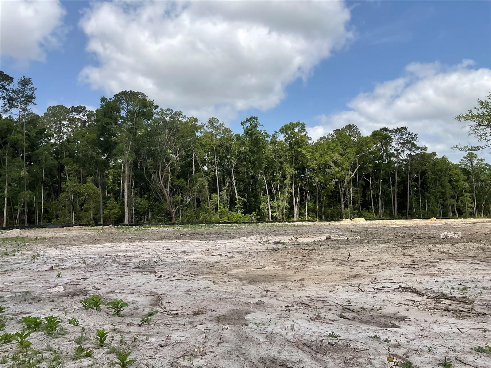 Beautiful, wooded, high and dry 4 acres contiguous to Oaks Preserve community, RE-1 zoning that allows for a density range of 1 per 2 acres to 2 per acre dwelling units as per Table 403.07.1 of the Alachua County, Florida - Code of Ordinances. The subject property pertains to the back 4 acres of the 6.8 acre of parcel 06941-008-000 , the new parcel will be created and recorded by seller once a contract is in place Permanent access to the acreage will be from SW 55th Rd of the Oaks Preserve community, temporary access will be given through the entrance to parcel 06941-008-000