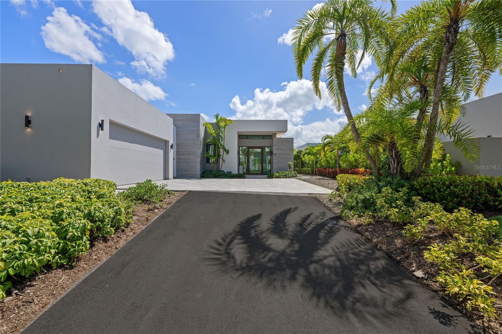 Welcome to a contemporary tropical haven in The Isles, one of Dorado’s most sought-after communities. This stunning residence blends modern elegance with island serenity, boasting clean architectural lines, soaring ceilings, and oversized windows that flood the space with natural light. From the moment you step inside, you’re greeted by a grand open-concept living area that flows effortlessly into the dining room and gourmet kitchen—ideal for entertaining or simply relaxing in style.
The heart of the home is its chef’s kitchen, beautifully appointed with premium appliances, sleek cabinetry, waterfall quartz countertops, and a central island ideal for entertaining. Floor-to-ceiling glass doors lead to a beautifully landscaped backyard complete with a covered terrace, outdoor lounge area, and a resort-style swimming pool—perfect for enjoying the Caribbean breeze. The primary suite offers a tranquil retreat with an expansive walk-in closet, and a luxurious en-suite bathroom featuring a freestanding soaking tub, dual vanities, and a glass-enclosed rain shower.
Set within a gated resort community, this home offers not only luxurious living, but also exclusive access to Dorado Beach’s world-class amenities. Residents enjoy 24/7 security, golf courses, beaches, tennis courts, and fine dining—all just minutes away. This property is a true gem in the Caribbean.