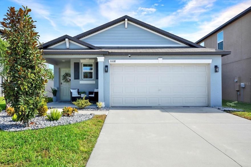 Welcome to this stunning turn-key 2023 single-story home in the desirable Berry Bay community! This beautifully maintained residence showcases modern interior design touches and an open-concept layout that seamlessly connects the kitchen, dining, and family rooms—perfect for entertaining and everyday living. The kitchen features quartz countertops, a tile backsplash, and designer lighting fixtures. The private owner’s suite offers a relaxing retreat with a walk-in closet and ensuite bath, while two additional bedrooms provide space for family or guests. Vinyl privacy fence and backyard with kid-safe play area, rubber mulch, and decorative rock garden. ADT security system with Google Home cameras included! Enjoy resort-style amenities—pool, clubhouse, pickleball and basketball courts, dog park, playground, and walking trails. Convenient to US-301, I-75, Tampa, St. Pete, and Sarasota.