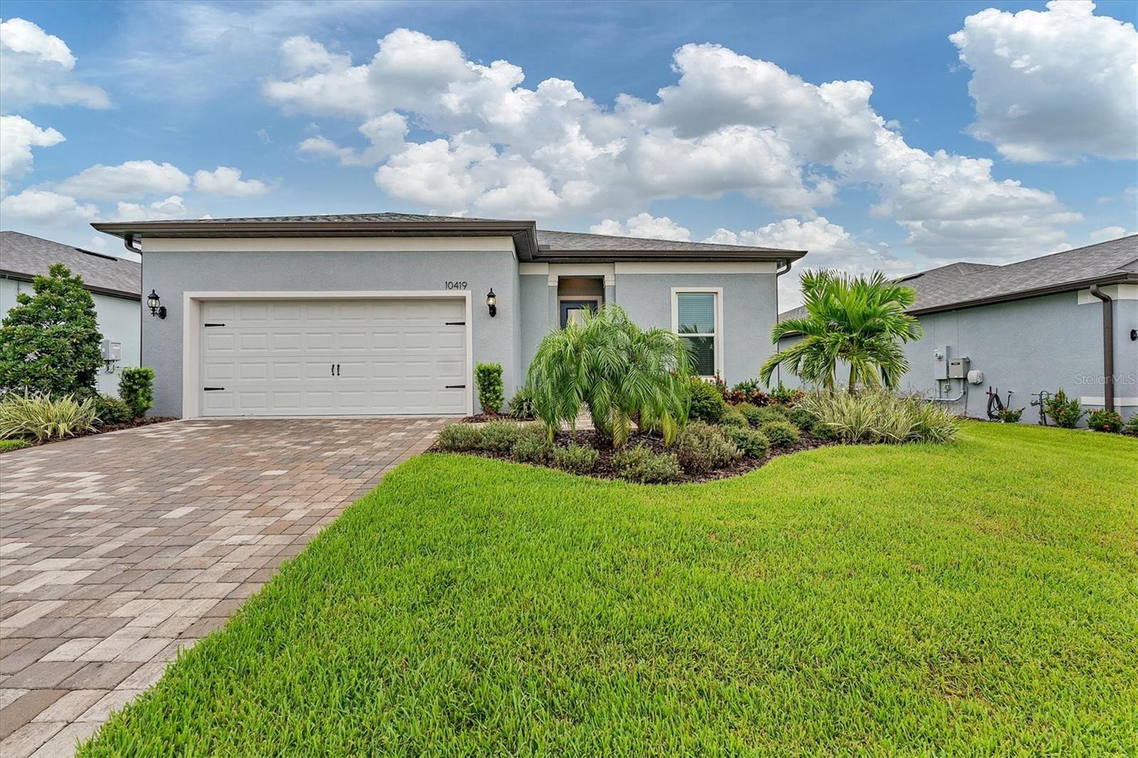 The MAINSTAY floorplan offers two bedrooms, two full bathrooms, a double French door den, and an extended 2-car garage. Homeowners appreciate the large inside laundry and the additional storage room. But it is the view of the big green conservation and blue skies that draws the homeowners to live their best life outside in the extended screen lanai. This home features impact-resistant windows and doors. The garage has plenty of room for two cars (or one car and a golf cart), plus massive storage. Luxury Vinyl plank floors provide easy care, maintenance-free living (no carpet anywhere) and the vast kitchen island can readily seat four. Kitchen features KitchenAid appliances and the home uses smart home technology. Home has an in-wall pest system, and original warranties are transferable. Used lightly for less than a season, the seller fell in love with the weather and built a bigger house. Located centrally to all DEL WEBB BAY VIEW amenities, (Driftwood Club, athletic courts, Fitness, community garden and pools and spa) this gated community is located 1.5 miles from I-75 and 275, making travel to airports, beaches, dining and shopping easy.