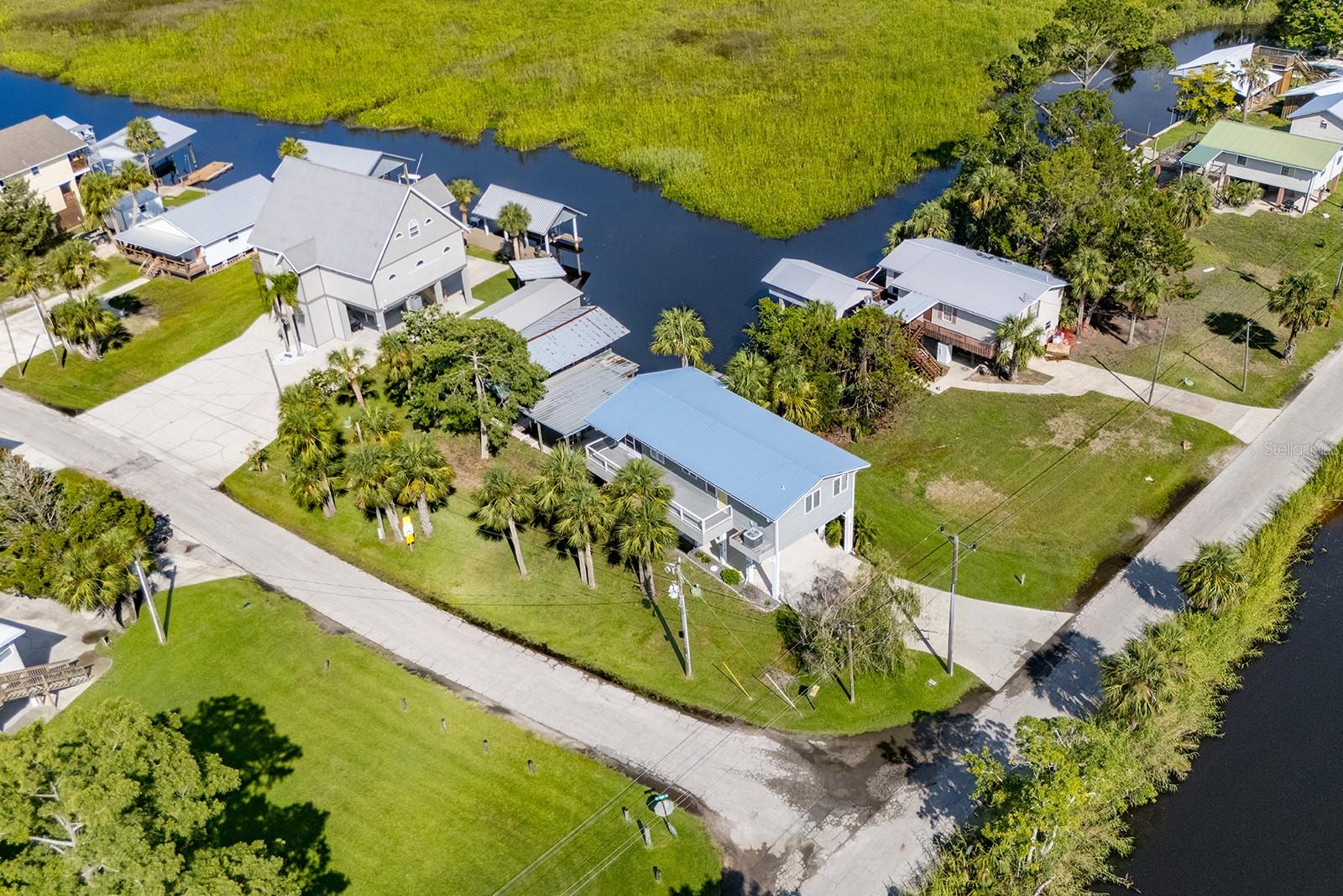 Discover the perfect waterfront getaway in the heart of Suwannee, Florida! This beautifully renovated 2-bedroom, 1-bath home sits on a freshwater canal with direct access to the Suwannee River, offering an ideal setting for boaters, anglers, and nature lovers alike. The property features a private boathouse with three boat slips, giving you immediate access to the water for all your adventures. Inside, the home has been thoughtfully updated with granite countertops, custom cabinets, and modern finishes throughout. Central air and heat ensure year-round comfort, with a wall unit in place for added peace of mind. An elevator adds convenience, while the screened-in room provides a comfortable spot to relax and enjoy the outdoors. Hurricane-rated doors and windows offer extra protection and durability. Whether you're looking for a full-time residence or a weekend retreat, this move-in-ready home blends style, comfort, and functionality in a prime waterfront location.