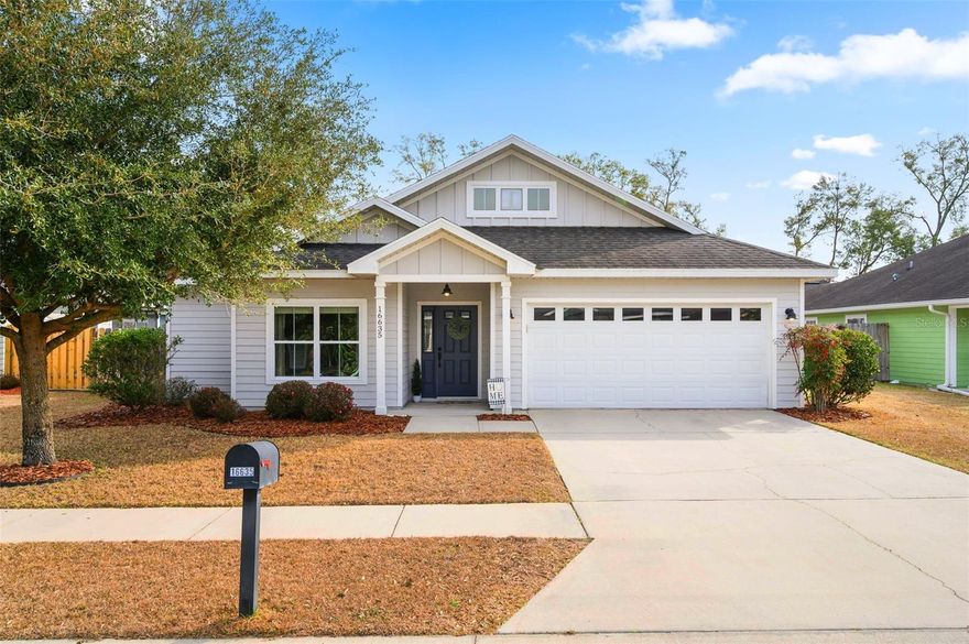 If you’ve been waiting for the perfect blend of modern style, functional space, and charm — this is it! Welcome to this beautifully maintained 3-bedroom, 2-bath Craftsman-style home offering 1,724 square feet of thoughtfully designed living space built by Howe Development in the popular Oak Ridge at High Springs neighborhood. From the moment you step into the welcoming foyer hallway, you’ll notice the attention to detail. Warm luxury vinyl plank flooring flows through the main living areas, complemented by crown molding and rich dark wood cabinetry in the kitchen that create a polished yet inviting feel. The gorgeous kitchen also features granite countertops, stainless steel appliances, soft-close cabinets and drawers, frosted glass cabinetry door accents, pantry, and a large island with seating and additional storage. The spacious open-concept living area truly is the heart of the home, seamlessly connecting the kitchen, dining, and living rooms under elegant crown molding, making entertaining effortless and everyday living comfortable. The split-bedroom floor plan offers privacy and flexibility for families or those needing a home office. Retreat to the luxurious owner’s suite with crown molding and a spa-like ensuite bathroom complete with a dual sink vanity with granite countertops, a relaxing soaking tub, glass-enclosed shower, linen closet for additional storage, and walk-in closet. Two additional bedrooms and the hall bath, also with a granite countertop vanity, are thoughtfully positioned on the opposite side of the home. Back in the main living area, French doors lead out to a charming covered patio and generous fenced backyard — perfect for weekend barbecues. A tankless gas water heater, fiber optic internet, underground utilities, and the attached two-car garage with workshop space and utility sink add even more value and appeal. Ideally located between Alachua and High Springs off US 441 with easy access to I-75, and convenient to shopping, dining, and Publix nearby — this home truly checks every box. Don’t miss this opportunity to make this beautiful home yours!