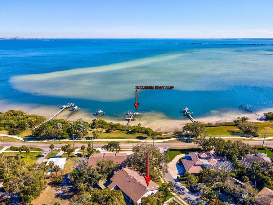 A rare find in Safety Harbor: Experience the ultimate boater’s lifestyle with a dedicated boat slip and 6,000lb lift paired with this beautifully maintained condo." This inviting 2-bedroom, 2-bathroom residence in charming Safety Harbor provides a spacious layout, perfectly positioned just three blocks from the vibrant downtown district. Lover's Oak is the only condo community in the area to offer exclusive waterfront amenities along its 144 feet of private shoreline. The updated interior features a practical split floor plan and crown molding throughout.  Tile throughout and cozy carpeting in both bedrooms.  The bright and cheery, oversized kitchen provides Granite countertops, stainless steel appliances and plenty of space for meal preparation or an additional dining area. Enjoy a screened-in patio off the front entry and an additional sun room off the living area which is perfect for an office/den, fitness area or playroom. 
The living room and master bedroom were enhanced in 2023 with new hurricane-impact windows, adding peace of mind and energy efficiency. The convenience of a large indoor laundry room makes everyday living a breeze, and an AC unit installed in 2020 ensures comfort year-round. Dock and kayak rack restoration was complete in 2025. Spend evenings at the dock’s picnic table, enjoying the twinkling lights of Tampa across the bay or watching for local wildlife like manatees, dolphins, and ospreys. The building exterior received a fresh coat of paint in 2025, and the roof is newer. The location delivers an authentic seaside experience; you can walk everywhere without needing a car. Stroll to the beautiful city marina, local parks, restaurants, boutique shops, art galleries, spas, the library, and the popular farmers market.
The community grounds host the historic Lover's Oak—a magnificent live oak tree believed to be over 200 years old, adding a unique layer of charm and heritage. Across the street, the Ream Wilson Trail will soon connect to 75 miles of scenic pathways throughout Pinellas County.
The Safety Harbor Resort and Spa, just three blocks away along the waterfront trail,  offers a refreshing, spring-fed outdoor swimming pool, a relaxing waterfront Tiki Bar and Grill, an indoor mineral pool, wellness and fitness classes, indulgent treatments, and discounts at its on-site restaurants. Ask me about the pool only membership or the Silver, Gold & Platinum memberships available. This condo provides easy access to Florida’s best beaches, sports venues, and airports. Embrace the blend of history and coastal living that you'll only get from this exceptional location. Schedule your private tour today.