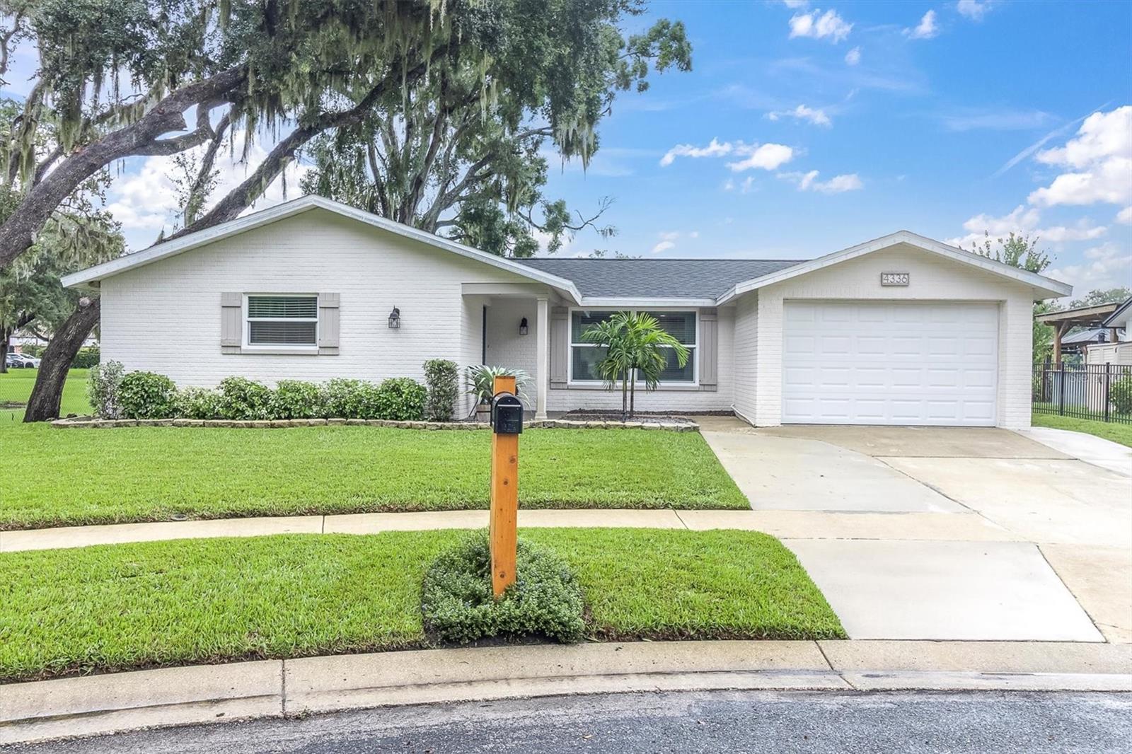 Wow! This beautifully updated 2-bedroom (possible 3-4) two bath home is located on a rare lot providing privacy on three sides and a cul-de-sac with gorgeous pond views. New hurricane impact windows 2022. Roof 2022. Electrical panel 2024. Water Heater 2024. Sprinklers 2024. Interior paint 2024. front door 2024. 2025 luxury vinyl flooring throughout. Large outdoor cottage(2020) is 20x10, and has its own electrical panel, insulated, heated, and ice-cold a/c. It would be the perfect office, workout room, or man cave/she shed. An additional Florida room is enclosed with windows, plus an additional patio with a private primary bedroom entryway. The fully remodeled kitchen has high-end granite countertops, wood shaker-style cabinetry, soft-close drawers, pull-out drawers for pots/pans, stainless steel appliances, a wide sink, a vented hood range, wood beams across the ceiling, a tall appliance cabinet/pantry, pass thru to the Florida room, and a large eat-in area. BONUS room inside the house could easily be a third bedroom, game room, or another office space. The primary bedroom has barn doors for the ensuite and walk-in closet. The second bedroom has a walk-in closet. Shiplap in living room. Brick wall entry foyer. Welcoming covered front porch. This home provides a variety of spacing needs. All bedrooms have fans. Home is fenced on three sides and could easily be fully fenced in. The oversized garage has a door opener. This home is not located in a flood zone, does not have an HOA. Located conveniently off of State Road 54, the highly desirable area is close to all the major conveniences of shopping, dining, hospitals, and schools. Only 15 minutes to the gorgeous Fred Howard Beach, and 40 minutes to Tampa International Airport.