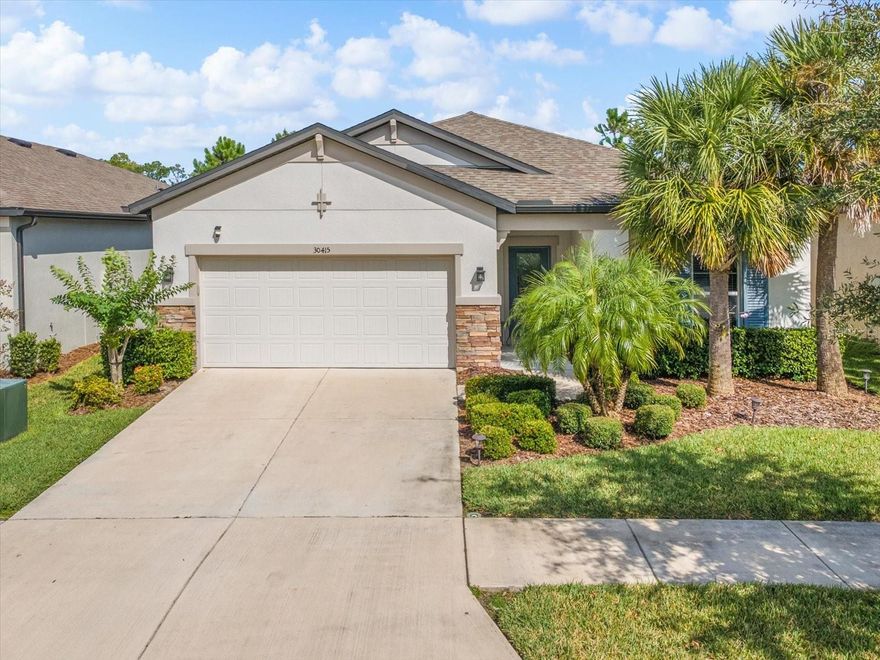 Welcome to 30415 Caravelle Lane — a beautifully maintained 2020 M/I Home located in the highly sought-after gated, resort-style community of Wesbridge. Offering over 2,200 square feet of living space, this home features 4 bedrooms, 3 full bathrooms, a versatile flex room, and a 2-car garage. Enjoy the Florida lifestyle on the extended screened lanai, with no rear neighbors for added privacy. The open-concept layout seamlessly connects the great room, dining area, and kitchen, all enhanced with plantation shutters. The chef-inspired kitchen boasts granite countertops, a large island with breakfast bar seating, and abundant cabinetry and counter space — perfect for cooking and entertaining. The spacious primary suite includes a luxurious en-suite bathroom with dual vanities, a walk-in shower, and two generous walk-in closets. Three additional bedrooms and two full baths provide ample room for family or guests. The flex room offers endless possibilities — ideal for a home office, playroom, or media space. Wesbridge residents enjoy access to premium amenities, including a resort-style pool, dog park, and playground. Conveniently located within walking distance to Wesley Chapel schools and just minutes from I-75, I-275, The Shops at Wiregrass, Tampa Premium Outlets, restaurants, parks, and top medical facilities. This move-in-ready home perfectly combines comfort, convenience, and modern style — ready for you to make it your own!