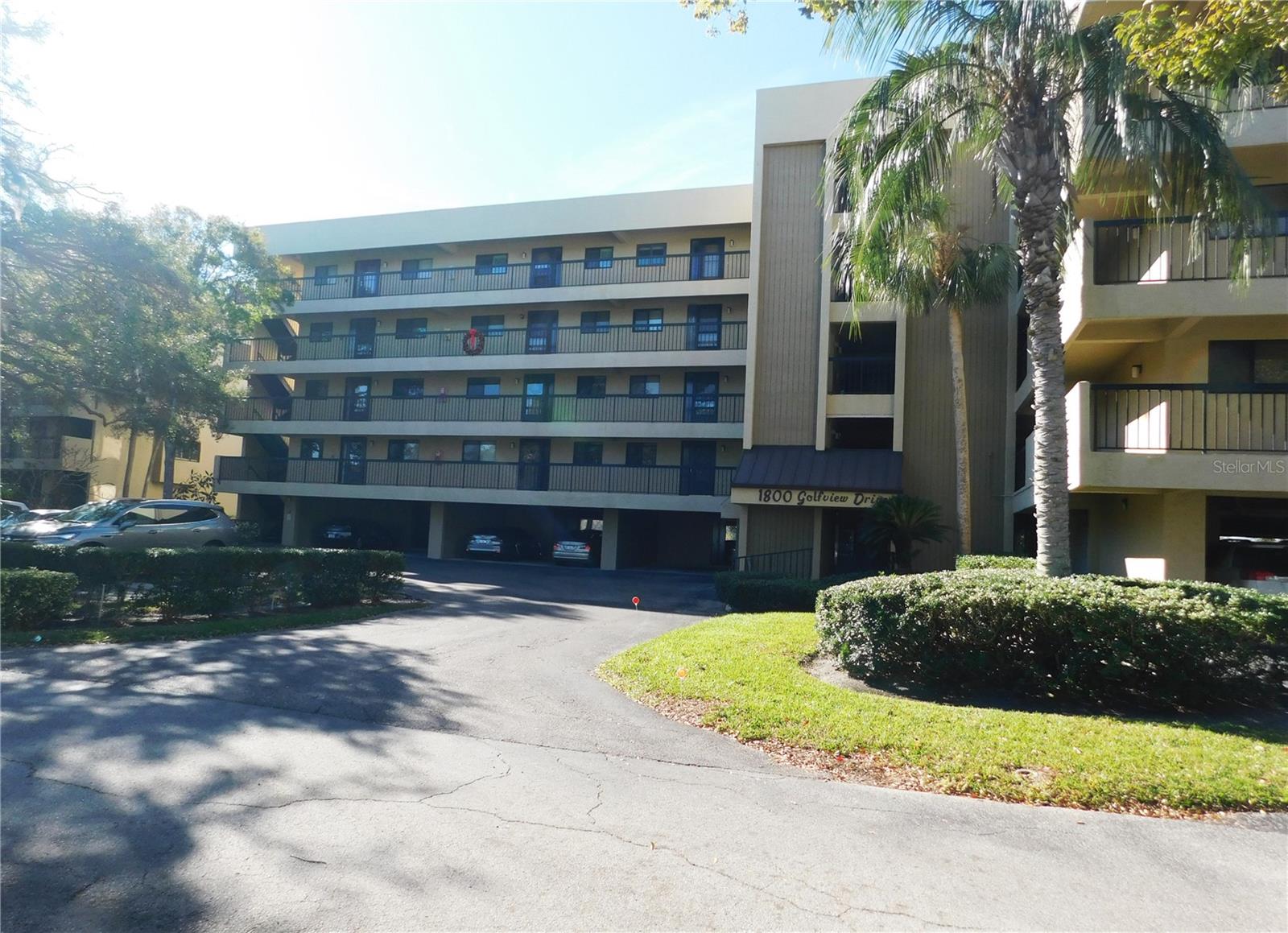 This spacious 55+ condo offers a bright, open floor plan with stunning views of the lush, tree-shaded Tarpon Springs Golf Course, pond and community pool as seen from your large screened tiled lanai. Step inside to discover an updated kitchen equipped with modern stainless steel appliances, and ample pantry space with additional tall built-in cabinets—perfect for all your culinary needs. The open-concept living and dining area flows to the lanai, perfect for relaxing or entertaining. The split-bedroom floor plan provides privacy, with the primary suite featuring a sitting area nook, walk-in closet, dual vanities, and a tub/shower combo. The second bedroom is near a full bath with a walk-in shower. A full-size washer and dryer are tucked into a spacious interior closet for added convenience. This unit comes with one reserved, covered parking spot on the ground level under building, and an additional storage unit—perfect for bikes, golf clubs, and more. Green Dolphin is a well-maintained 55+ community that includes water, trash, high-speed internet, cable and elevator access. Amenities include a heated pool, clubhouse, fitness center, tennis and pickleball courts, shuffleboard, billiards, BBQ area, and walking trails. Located minutes from the Tarpon Springs Sponge Docks, downtown shops and restaurants, Pinellas Trail offers miles of scenic paths for biking and walking, beaches, and medical facilities. Golfers can find many courses nearby to tee off from including Tarpon Springs Golf Course, Copperhead Course, Innisbrook, and Islands Golf Course. This is a non-smoking residence and the owner prefers no pets please.