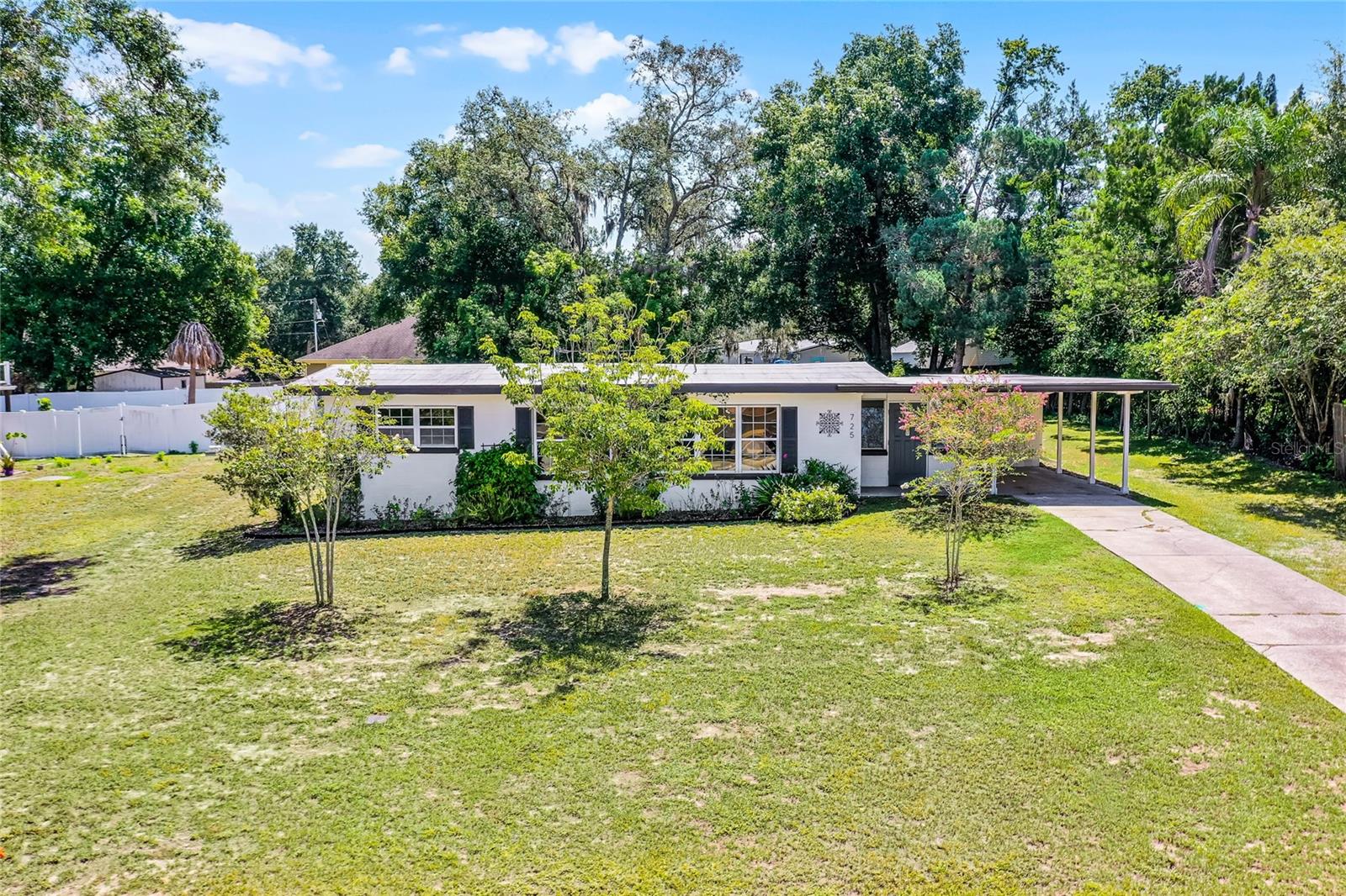 Vintage Style meets Modern Comfort – With Golf Cart Access to Downtown Clermont!
Location matters, and this thoughtfully updated mid-century retreat has it all. Nestled in Clermont’s expanded Golf Cart District, 725 East Avenue blends classic charm with over $90,000 in updates that elevate comfort, style, and functionality. Built in 1954, this 2-bedroom, 2-bath home offers 1,367 square feet of light-filled living space on a lush 0.29-acre lot bursting with edible gardens and shade trees.
Extensive enhancements from 2021 to present ensure peace of mind: a whole-house PEX re-pipe, relocated water heater, refreshed lighting, crawlspace AC duct replacement, premium ceramic window tinting, reflective rubber aluminum roof coating (10-year durability), and high-quality interior/exterior paint throughout. **At the heart of the home, a beautifully remodeled kitchen features a quartz peninsula, expanded pantry, modern cabinetry, elegant marble look rigid core luxury vinyl tile (in bathroom too), and vintage-style paneling. The spa-inspired bathroom includes a deep soaking tub/shower combo, an expanded vanity, and elegant tile finishes, designed for daily indulgence.
A private rear suite with separate entrance, full bath, and built-out kitchenette (sink, mini fridge, microwave, and storage) offers versatile living, ideal for guests, extended family, or continued Airbnb rental. The breezy sunroom adds character with jalousie windows and a tucked-away laundry area.
Outside, discover a true garden oasis: Tabebuia and Crape Myrtle trees bloom alongside raised beds brimming with sweet potatoes, pineapples, pigeon peas, avocado, lemon, lime, aloe, turmeric, ginger, eggplant, tomatoes, peppers, yucca, milkweed, passion fruit, marigolds, rosemary, and roses.
And the location? It’s a lifestyle. Cruise downtown by car, golf cart, bike, or foot to enjoy artisan shops, restaurants, the ever-popular farmers market, and the many events and festivals throughout the year. Minutes from the Chain of Lakes, scenic trails, major highways, and top-rated schools, Clermont offers vibrant charm and convenience.
Whether you're headed to brunch, Waterfront Park, or the next local event, every outing feels like a celebration. Clermont’s motto is “Choice of Champions”, and this home fits the title. Schedule your showing today or view the video walkthrough to experience the unique charm of this beautiful home.