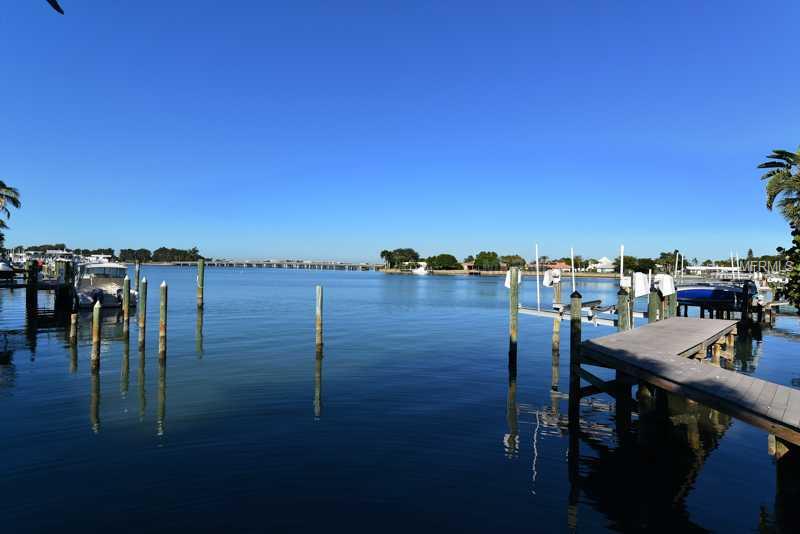 Sprawling Bird Key Waterfront Estate with spectacular water views and breathtaking sunsets! Situated on an oversized lot, this contemporary masterpiece offers over 6,000 square feet of indoor living space with 5 bedrooms, 5 bathrooms, 1 half bath, 3 car garage, great room, formal dining room, chef's kitchen with breakfast nook, family room, and laundry room. A private, lushly landscaped courtyard greets guests upon arrival. Once inside, the clean lines and open space emphasizes the two-story windows overlooking the water; volume ceilings with striking high-end light fixtures; sumptuous pure white Greek Thassos marble and African mahogany flooring; and a dramatic staircase leading to the second story. The great room also features a direct vent gas fireplace with remote control. The Master Suite was rebuilt in 2007 and faces due west, providing views of the Yacht Club, not to mention the sunset! There is a great bonus addition with fabulous water views; keep it as a game room, convert to one or two bedrooms, or transform to a private access two-story guest house or mother-in-law suite. Just use your imagination! All windows are impact, or else have hurricane screens for protection. The Trex dock was new in 2006 and features a 10,000 pound lift. The seawallwas recently inspected and is in good condition. Some furnishings are available to be purchased outside of closing. Come experience the Bird Key lifestyle!