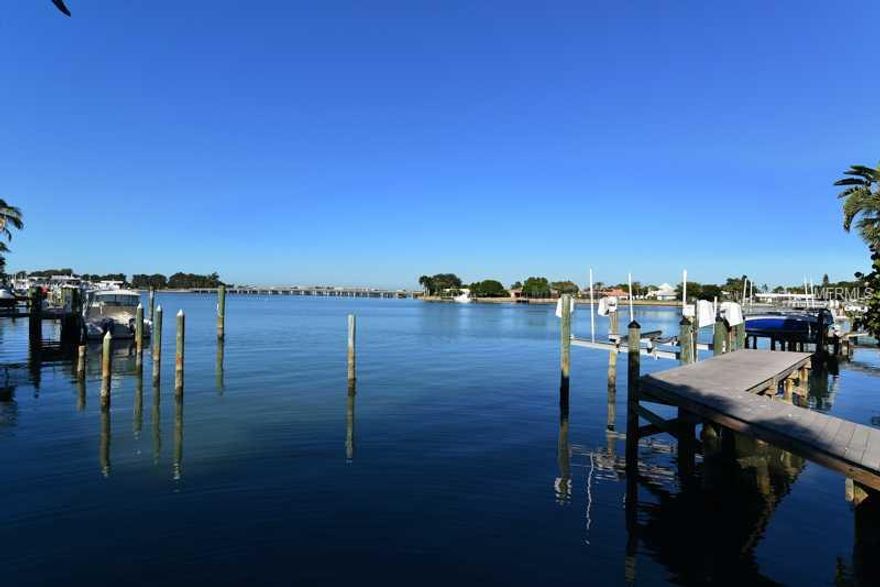Sprawling Bird Key Waterfront Estate with spectacular water views and breathtaking sunsets! Situated on an oversized lot, this contemporary masterpiece offers over 6,000 square feet of indoor living space with 5 bedrooms, 5 bathrooms, 1 half bath, 3 car garage, great room, formal dining room, chef's kitchen with breakfast nook, family room, and laundry room. A private, lushly landscaped courtyard greets guests upon arrival. Once inside, the clean lines and open space emphasizes the two-story windows overlooking the water; volume ceilings with striking high-end light fixtures; sumptuous pure white Greek Thassos marble and African mahogany flooring; and a dramatic staircase leading to the second story. The great room also features a direct vent gas fireplace with remote control. The Master Suite was rebuilt in 2007 and faces due west, providing views of the Yacht Club, not to mention the sunset! There is a great bonus addition with fabulous water views; keep it as a game room, convert to one or two bedrooms, or transform to a private access two-story guest house or mother-in-law suite. Just use your imagination! All windows are impact, or else have hurricane screens for protection. The Trex dock was new in 2006 and features a 10,000 pound lift. The seawallwas recently inspected and is in good condition. Some furnishings are available to be purchased outside of closing. Come experience the Bird Key lifestyle!