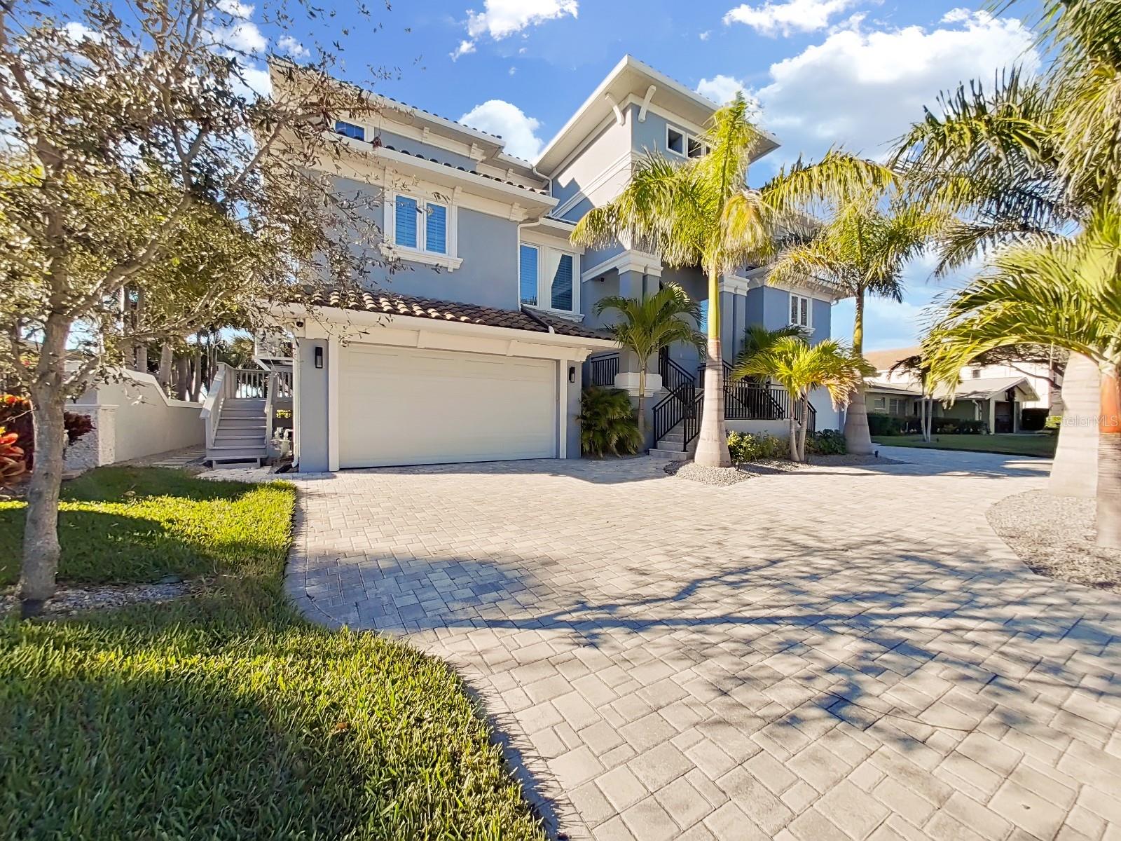 This immaculate home is located in one of the most sought after and exclusive streets in Harbor Bluffs. As you enter the neighborhood over its private bridge, the first thing you will notice is the privacy that only an island can have. Built on a slab with pillars, this house is a truly rare home from just that aspect. The first floor is a garage fanatics dream with more than enough room for multiple cars, charging stations on both sides and a elevator that can take you to any floor. Want an oasis? Then your in luck! As you go to the back yard, you'll have to note the huge hot tub with its own drop down television for entertaining. Want to swim, just a couple more feet and your in your own private heated salt water pool with a built in walking deck. Want to go out in the intercoastal, then jump off the dock and your in the water. The kitchen is a "foodies" dream with high end appliances, a huge middle island, a huge pantry, and who wouldn't want to have a water view while you cook? Walking through the house on the true hardwood floors is another amenity that makes this house a true diamond that you will be hard pressed to find in other newer homes. Two master bedrooms make it easy to entertain, and bedrooms spread out on multiple floors will give everyone their own privacy. Boasting multiple a/c units/multiple zones with uv light package, gas appliances, on demand hot water, a Generac generator, voice controlled black out power shades across the back of the home, brand new exterior ceiling fans, this home is where you need to be. Upgrades and refinement is what this house brings, its a must see for any buyer!