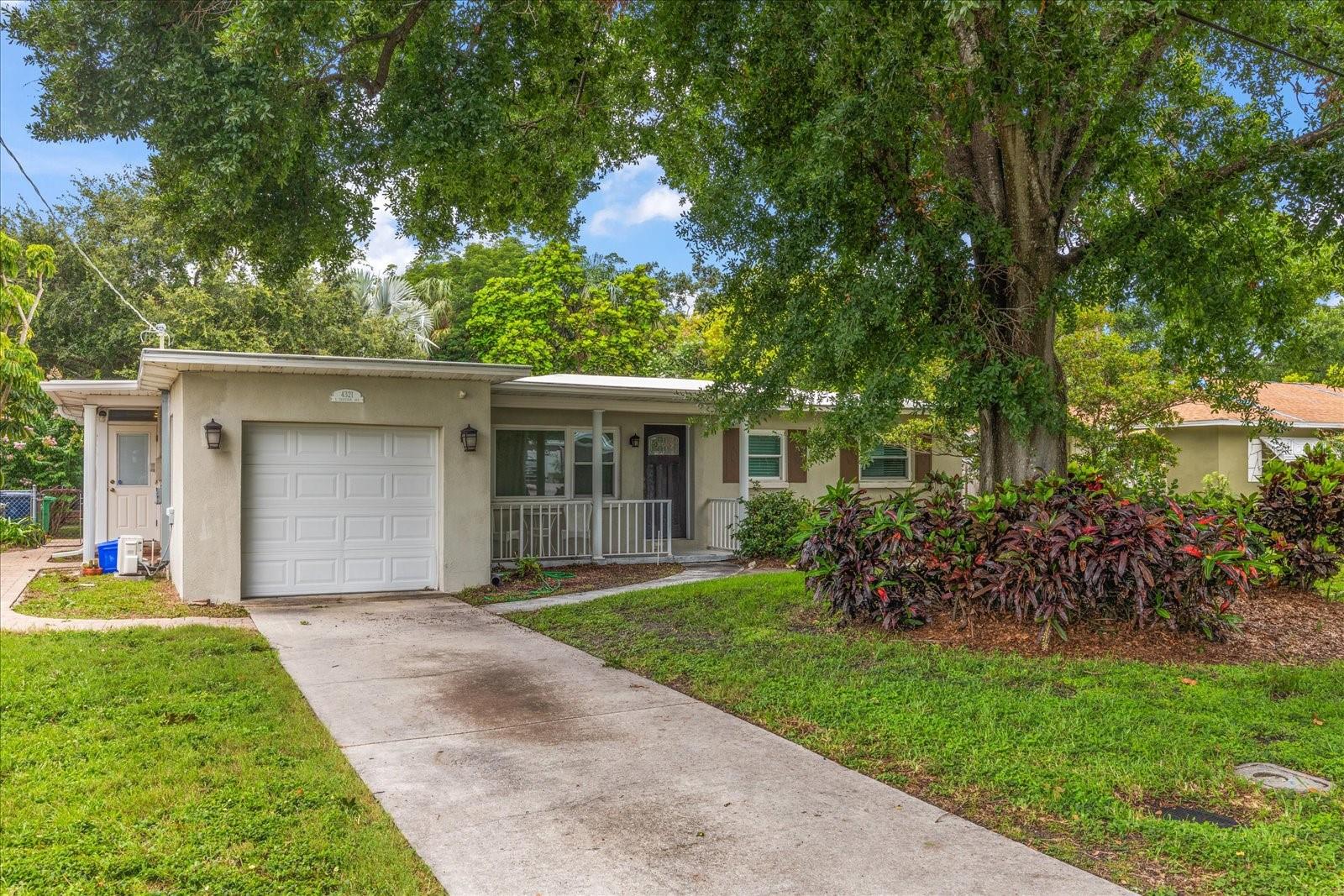 Come see this charming 3 bedroom, 1 bathroom move-in-ready home located on an oversized lot in the heart of South Tampa—just minutes from Bayshore Blvd, MacDill AFB, shopping, dining, and parks. Within walking distance of the new Adum K-8 Magnet School, this home offers both convenience and room to grow. Build a future primary suite or design your dream home on this spacious property. Inside, enjoy an updated kitchen with sleek quartz countertops, stainless steel appliances, and a breakfast bar that opens to a bright Florida room—ideal for entertaining or everyday living. The updated bathroom features a walk-in shower with neutral tile throughout. Original wood floors flow through the living room and bedrooms, while luxury vinyl tile adds style and durability to the kitchen, dining, and Florida room. Additional upgrades include hurricane-rated double-pane windows (2020), HVAC system (2021), and a TPO membrane roof (2013) with a 30–40 year lifespan. A one-car garage with built-in cabinets, full-yard irrigation, and a fenced backyard with paver patio and shed complete the package. Don’t miss this opportunity to own a beautifully maintained home with space, charm, and a prime South Tampa location!