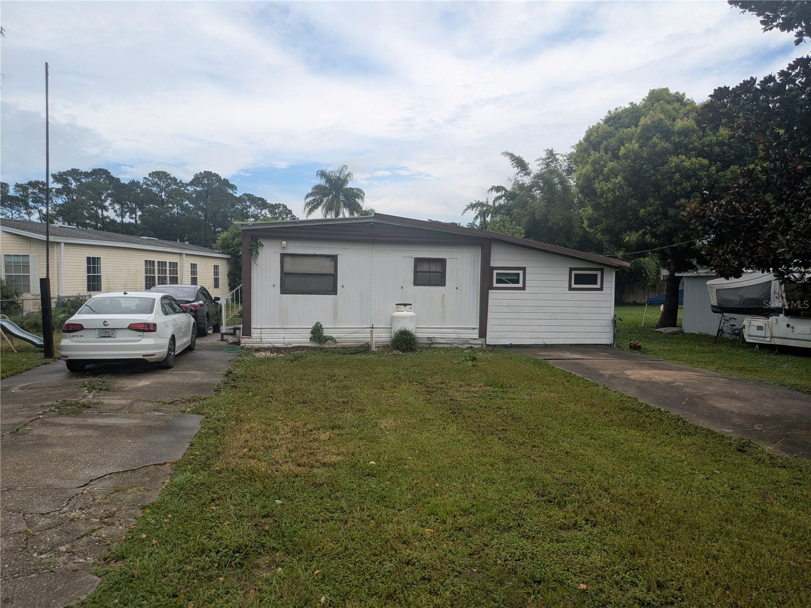 Clean, well taken care of, mobile home with a boathouse on a canal that leads directly to Little Lake Harris; perfect for a vacation home, a spot to launch your boat, or a great investment for buy and hold!