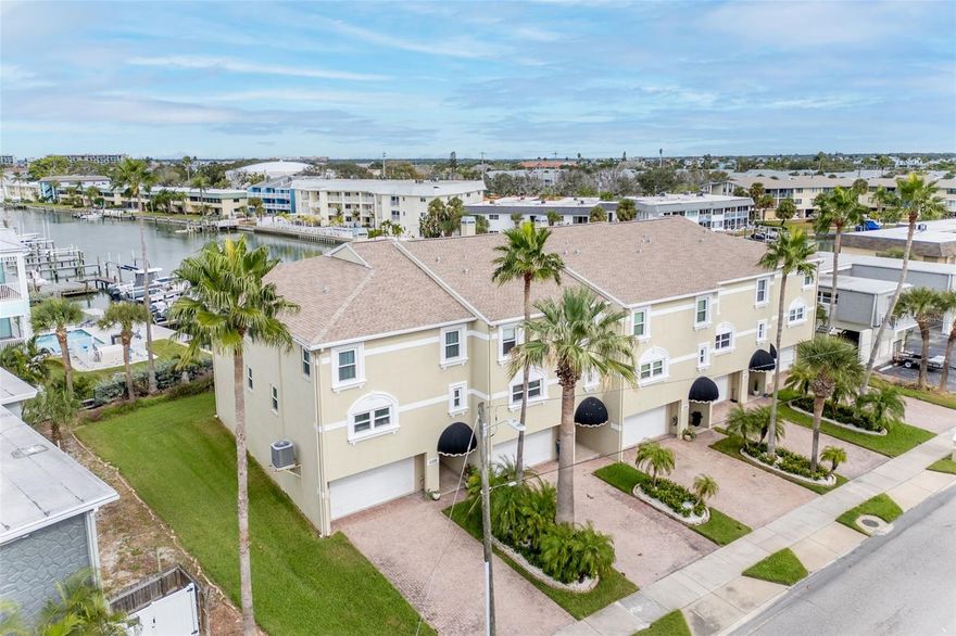 Welcome to Island Townhomes.  Located just a short block from the beautiful white sands of Treasure Island Beach.  This townhome is centrally located in the city of Treasure Island and walking distance to shops, restaurants, and the beach.  This end unit features a tandem 3 car garage and elevated living.  A beautiful view of the intercoastal waterway is to be admired from the spacious living room as well as the private balcony of the primary bedroom.  This townhome features open floorplan living on the main floor and generous bedrooms on the third floor.   This home is in pristine condition and comes with most of the furnishings.  Come see this beautiful home today.