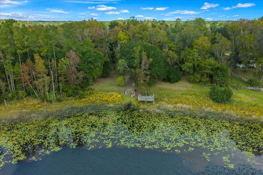 Discover 13.61 breathtaking wooded acres with stunning lakefront views of Hall Lake. Towering magnolias and mature hardwoods create a serene, southern plantation-like setting—right here in Florida. Conveniently located near the intersection of County Road 214 and County Road 315, the property offers an easy commute to Keystone Heights, Palatka, Middleburg, Orange Park and Jacksonville. The existing block home has had some updates but will require repairs in order to occupy. Renovate the current structure or choose to demolish and rebuild—NO IMPACT FEES apply either way. There is a minimum 750 sq. ft. residence requirement. The home/property is being sold AS-IS and includes an easement providing access to a neighboring 1-acre vacant wooded lot on Hall Lake. An additional 7.95-acre tract is also available for purchase under a separate listing. Agriculture Exempt status may be possible if Clay County criteria are met. This unique lakefront estate offers remarkable natural beauty, privacy, and potential—ready for your vision.