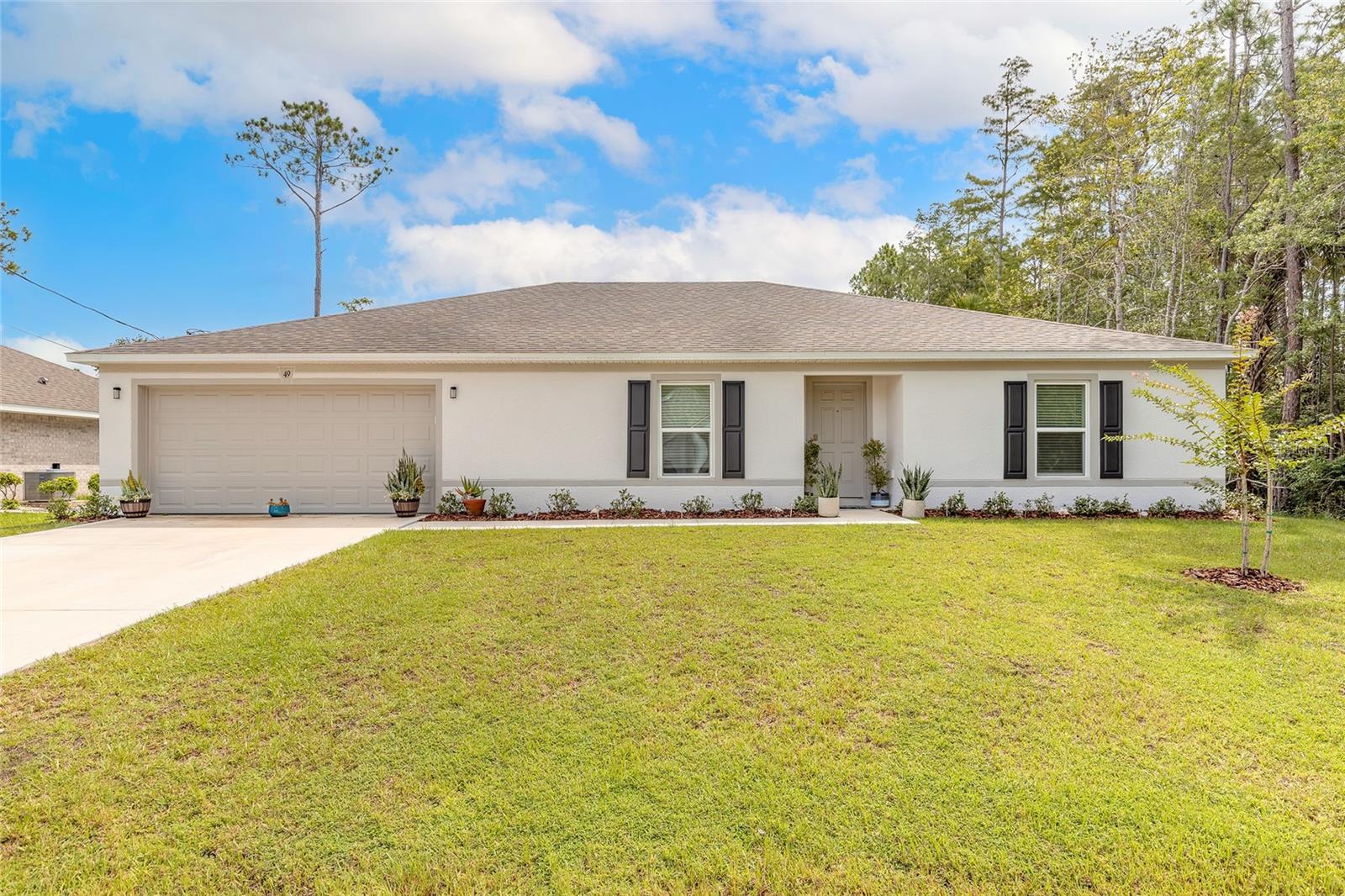 Welcome to your dream home nestled in the heart of beautiful Palm Coast! This immaculate 4-bedroom, 2-bathroom residence with a dedicated office space offers the perfect balance of comfort, functionality, and elegance. From the moment you arrive, you'll be captivated by the impeccable landscaping that surrounds the home, creating stunning curb appeal and setting the tone for the serene lifestyle that awaits inside. Step through the front door into an open and inviting floor plan designed with both daily living and entertaining in mind. The spacious living room flows seamlessly into the kitchen, which is complete with ample counter space, a large breakfast bar, stainless steel appliances, and a clear view into the main living area so you never miss a moment with family or guests. The private office offers the perfect space for remote work, hobbies, or a quiet retreat. Each of the four bedrooms is generously sized, providing plenty of space for family, guests, or a growing household. The primary suite features a walk-in closet and a beautifully appointed ensuite bathroom. Step outside and discover your very own backyard oasis—lush landscaping, swaying palms, and mature greenery create a completely private and tranquil escape. Whether you’re hosting a summer barbecue or enjoying a quiet morning coffee, this outdoor space is sure to become your favorite spot. Located just minutes from local shopping, dining, and entertainment, this home offers both convenience and a peaceful, retreat-like atmosphere. Don’t miss your chance to own this stunning Palm Coast gem! All information deemed accurate but can not be guaranteed.