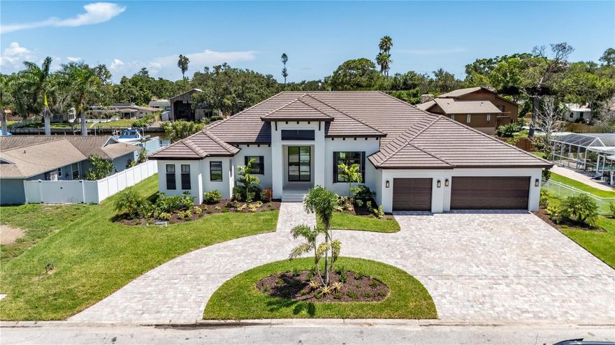 The Abaco Model is the perfect Sarasota Luxury home sporting 4,343 sf of living space and 6,273 sf under roof.   Upon arrival through the 10 ft high Iron Front Doors, the Foyer provides a direct view through the house to the pool and canal at the rear of the backyard.  The oversized Great Room has ample space for entertaining and includes stained cypress beams, a gas fireplace with full height tile surround, and a 16-foot wide by 10-foot high pocketing sliding glass door to the Outdoor Living/Pool Area. The Kitchen features an oversized Island with a gas cooktop, walk-in Pantry and windows above the sink for natural light. The Private wing of the home includes a Library/Office adjacent to the Owner's Suite, both of which have open water views.  Two large walk-in closets provide plenty of space for the Owner's wardrobe. The Owner Bath includes a private water closet, walk-in shower, free stranding tub and separate his and her vanities.  The home includes two additional Guest Suites each of which will accommodate king sized beds.  Both Guest Suites feature ensuite baths and walk in closets. The Bonus Room at the rear of the home has commanding views to the water.  A nearby full bathroom serves as a Powder Bath and Pool Bath.  The large Outdoor Living and Dining Area overlooks the Pool and Spa and includes a cozy gas fireplace. Arriving through the 3-car garage you will find a walk in Laundry Room with a storage closet.  All windows and exterior doors have Low E impact glass.  All interior doors are 8 ft high Shaker Style doors. All interior walls include sound batts.  Walls and ceilings have a smooth finish (no orange peel).  All interior floors are tiled.  Cabinets are Wood Mode/Brookhaven. The West Indies designed exterior front elevation includes shutters, corbels and brackets, and a concrete tile roof. The dock includes a high capacity 33,000 pound boat lift with water and power. With the capacity for large 40-50 ft vessels, this property is perfect for the serious boater who needs protected berth with quick access to Sarasota Bay.