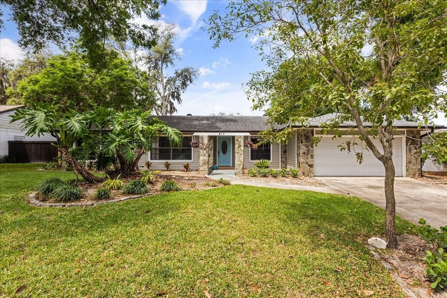 Welcome to 817 E. Harbour Court in Ocoee. This move-in ready home offers a flexible single-story layout, natural light, and a desirable split bedroom floor plan designed for both comfort and privacy. The front entry opens to a dedicated dining space and a separate office or flex room, while the main living room features a striking stone fireplace and flows into a spacious family room with vaulted ceilings and views of the screened patio. The centrally positioned kitchen is functional for everyday living and offers painted cabinetry, generous counter space, a breakfast bar, and an adjacent dining area with a warm wood accent wall. The private primary suite is tucked away from the secondary bedrooms, enhancing the split bedroom layout, and includes an updated en suite bath with a walk-in shower. Secondary bedrooms are set on the opposite side of the home, offering flexibility for guests, household members, or work-from-home needs. Outside, the screened patio extends the living space and overlooks a large fenced backyard with mature trees and an additional open patio area well suited for entertaining or relaxing. Conveniently located with access to shopping, dining, and major roadways. With a practical layout, inviting indoor-outdoor living, and multiple flexible-use spaces, this home delivers a thoughtful balance of privacy, openness, and everyday convenience.