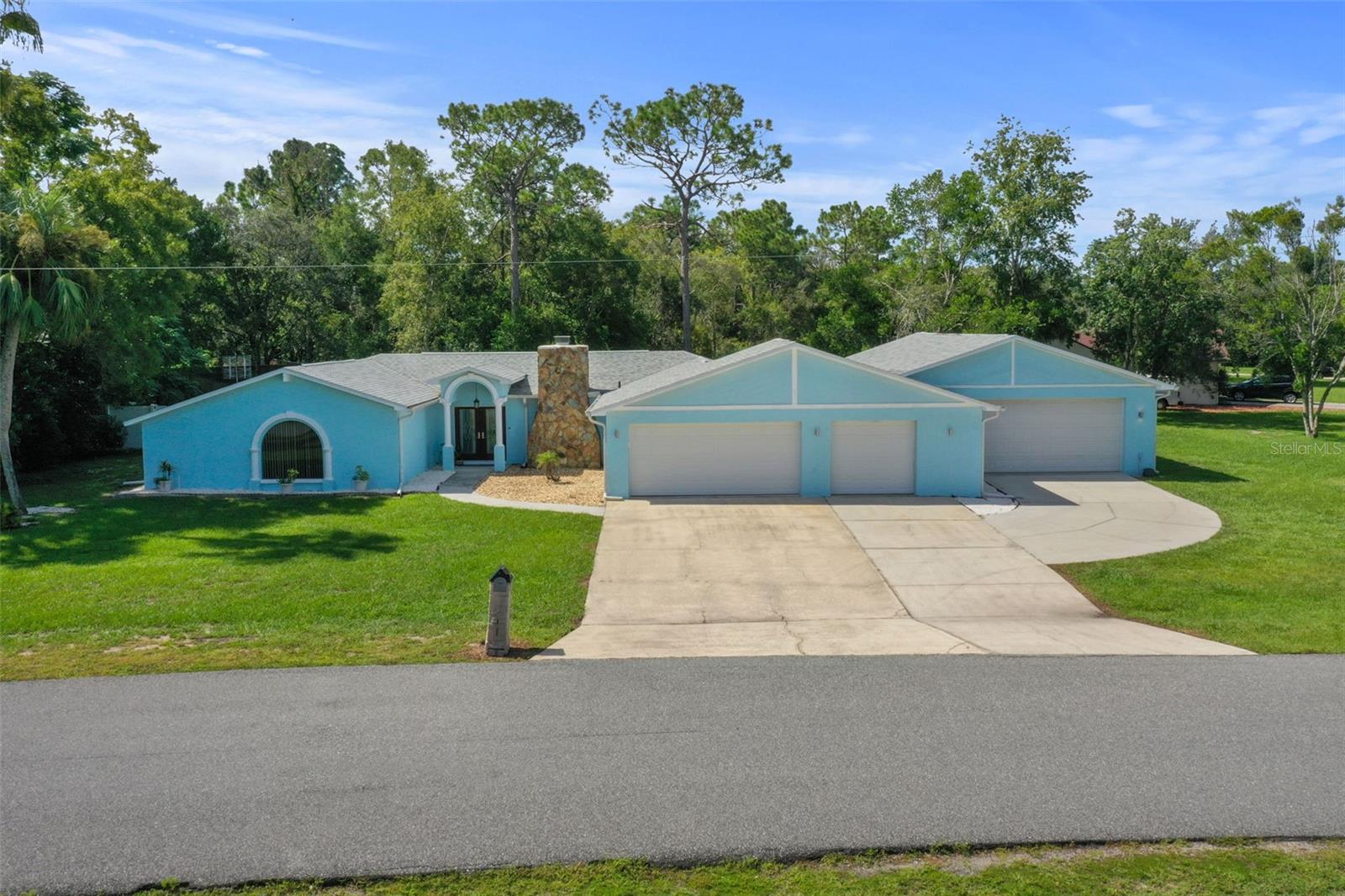 Love Cars or Need Extra Space? This one-of-a-kind Spring Hill home is a dream for auto enthusiasts, hobbyists, and anyone who needs room to spread out. Situated on over half an acre with an oversized driveway, it offers unmatched garage space: a massive 30×40 garage, a traditional 2-car garage, and a smaller garage perfect for a golf cart or motorcycle - all attached and insulated. The large garage is equipped with a 2-ton window AC, making it ideal for year-round projects. Bring all your toys, there’s even room for RV and boat parking behind the double gated fence. Inside, the great room welcomes you with soaring beamed cathedral ceilings, a cozy wood-burning fireplace, and vinyl flooring running throughout. The spacious kitchen features solid cherry wood cabinetry, granite countertops, stainless steel appliances, a large walk-in pantry and ample counter space for cooking and entertaining. A formal living room at the front of the home offers versatility for a home office, den, or an additional sitting area. The primary suite features a newly installed mini split system for added comfort, along with a large walk-in shower, separate tub, granite double vanity, walk-in closet, and wide doorways for accessibility. The split floor plan offers two additional bedrooms and a stylish hall bath; one bedroom includes a built-in Murphy bed, perfect for a multipurpose guest room or office. Enjoy Florida living outdoors with a large screened lanai overlooking the expansive backyard and above-ground pool, perfect for gatherings or relaxing evenings. Located in the heart of Spring Hill, you’re just minutes from Floridas nature coast, the Suncoast Parkway, Weeki Wachee Springs, shopping, dining, parks and grocery stores. Garage space like this is nearly impossible to find, bring every car, cart, bike, and boat…and still have room to spare! Don’t miss your chance! Ask about the 2.8% assumable VA loan, an incredible opportunity for qualified buyers!