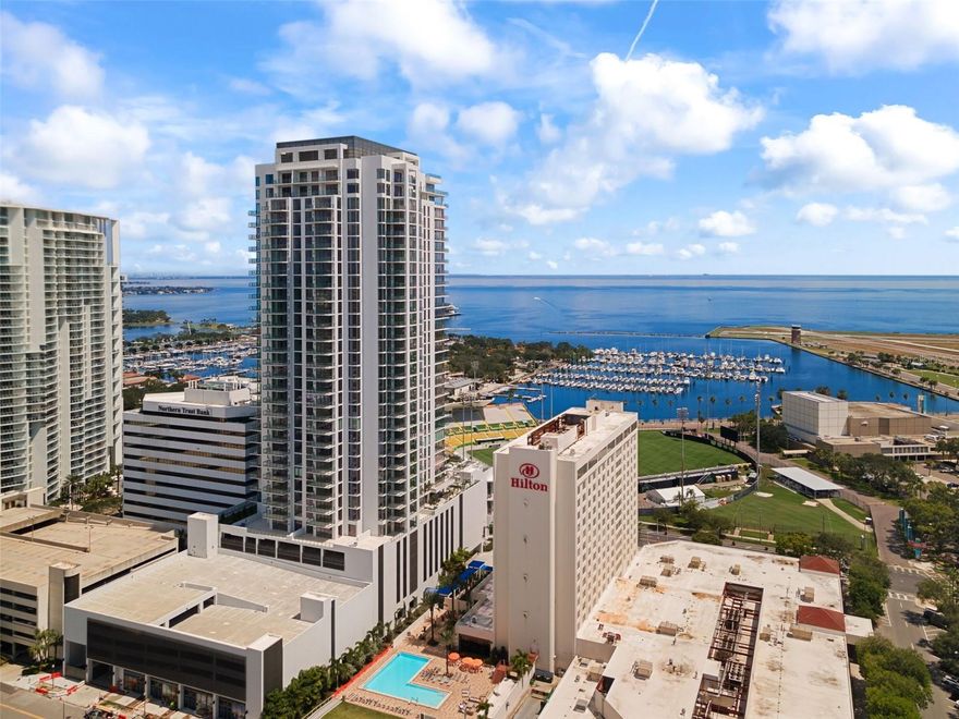 One or more photo(s) has been virtually staged. Welcome to Saltaire – Downtown St. Petersburg's Latest Luxury Location! Be among the fortunate few to own the coveted floor plan that sold out quickly upon release! Presenting a "Liner” loft-style residence with expansive views, this newly constructed 2 bedroom, 2.5 bathroom condo offers a lifestyle of magnificence. Through two stories of glass, enjoy breathtaking vistas that encompass historic Al Lang Stadium, the St. Petersburg marina basin, Tampa Bay, the Mahaffey Theatre, and the renowned Dali Museum. Privacy is the
hallmark of this residence, with only five Liner residences per floor and a separate elevator for lobby access. The home comes with two conveniently located 4th floor parking spots just steps from your front door and a storage locker on the same floor for amazing convenience. This condo boasts an array of luxurious finishes, including 24" x 48"matte-finish porcelain tiles throughout the living areas. The kitchen and bathrooms feature contemporary European-style cabinetry, exquisite quartz countertops, and frameless Euro Shower doors. The two generously sized living spaces provide flexibility for various lifestyle needs, whether it's entertaining, working from home, or simply creating your personal sanctuary. The well-appointed bedrooms, one on each level, come with en-suite bathrooms and balcony access, allowing for ample comfort and natural light. The second level owner’s suite has a 2nd private balcony with water views and two closets. The large 4th floor terrace is the perfect location to enjoy the sunrise, the excitement of a Rowdies game, the sights of planes arriving and departing the Albert Whitted Airport AND there’s few better locations downtown to enjoy the annual St. Pete Grand Prix. Saltaire offers an array of amenities, including optional valet parking, a dedicated front desk staff, and on-site property management for ultimate convenience. Residents can indulge in the expansive pool deck, outdoor kitchen area, and cabanas with stunning views of the waterfront,
downtown Tampa and the bay. Stay fit in the well-equipped fitness area and workout studio, unwind in the news café, enjoy time with your furry companion at the 7th floor dog park, and entertain in the stylish club room. Elevate your expectations: Saltaire delivers on its promise of luxurious living and places you within blocks of St. Petersburg's vibrant urban core. Savor the city's offerings with waterfront views a few blocks away from the hustle of Central Avenue. Don't miss the opportunity to experience the new pinnacle of new construction luxury living in Downtown St. Petersburg. Schedule your exclusive private tour today!