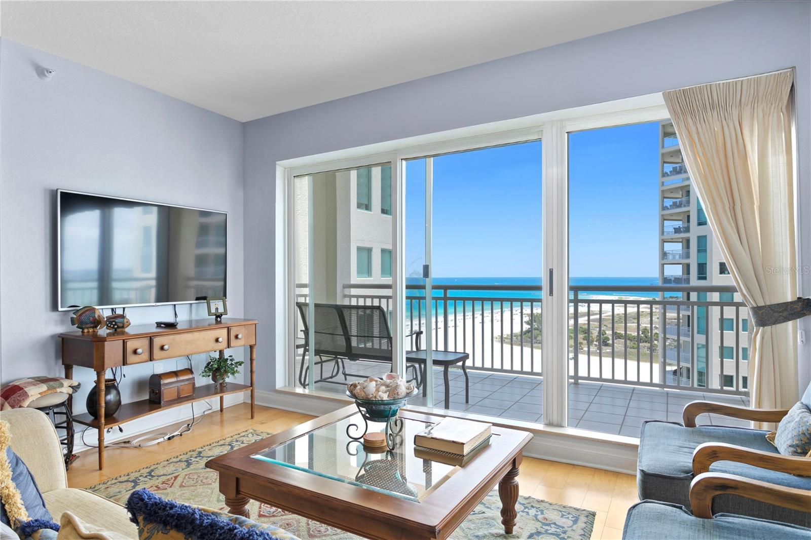 This property is available for lease asap for 6-12 months (flexible). Sit back and relax as you watch the breath-taking sunsets from your balcony or poolside at The Grande. The Grande will make you feel like you are living the life of the rich and famous. Residence features western beach views as well as eastern intracoastal views for a view at any time of day! Previous model for the complex, you will notice many upgrades such as built-in breakfast table as well as artistic decor. Both bedrooms as well as the living room have sliders that enter the balcony! Hardwood floors throughout are quite convenient. This luxurious complex has all the amenities that you could dream of - 2 pools, poolside canopied cabanas, a large spa, 2 lighted tennis courts, 2 fitness rooms, sauna/steam room, 2 club rooms with formal parlors and kitchens, 2 board rooms, a library/reading room, as well as, 2 billiard rooms. This complex also offers lush, manicured landscaping, 24-hour manned security, and a concierge staff to assist you as needed. In addition, there is underground parking space. Completely furnished except for sheets/linens and kitchen items. Lease includes water/trash, tenant pays electric and cable/internet. New fridge!