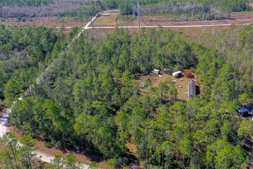 10 Acres of Opportunity in DeLand - Investor Special! Looking for space, privacy, and serious potential? This 10-acre property in the desirable 32724 area of DeLand offers the perfect blend of rural freedom and smart investment opportunity. Surrounded by estate-style homes and conveniently located just minutes from Interstate 4, you get privacy without sacrificing accessibility. The property includes a 2006 manufactured home - WHICH HAS NO VALUE  (924 sq ft) ready for your vision. Renovate it, rent it, replace it, or live in it while you build your dream home - the choice is yours. With portions of the land already cleared, there's ample space to expand, add additional structures, create a mini-farm, or design a private country estate. Enjoy peaceful surroundings while staying close to shopping, dining, medical facilities, and major commuting routes. This is the kind of acreage buyers are searching for -- flexible, usable, and in a growing area.