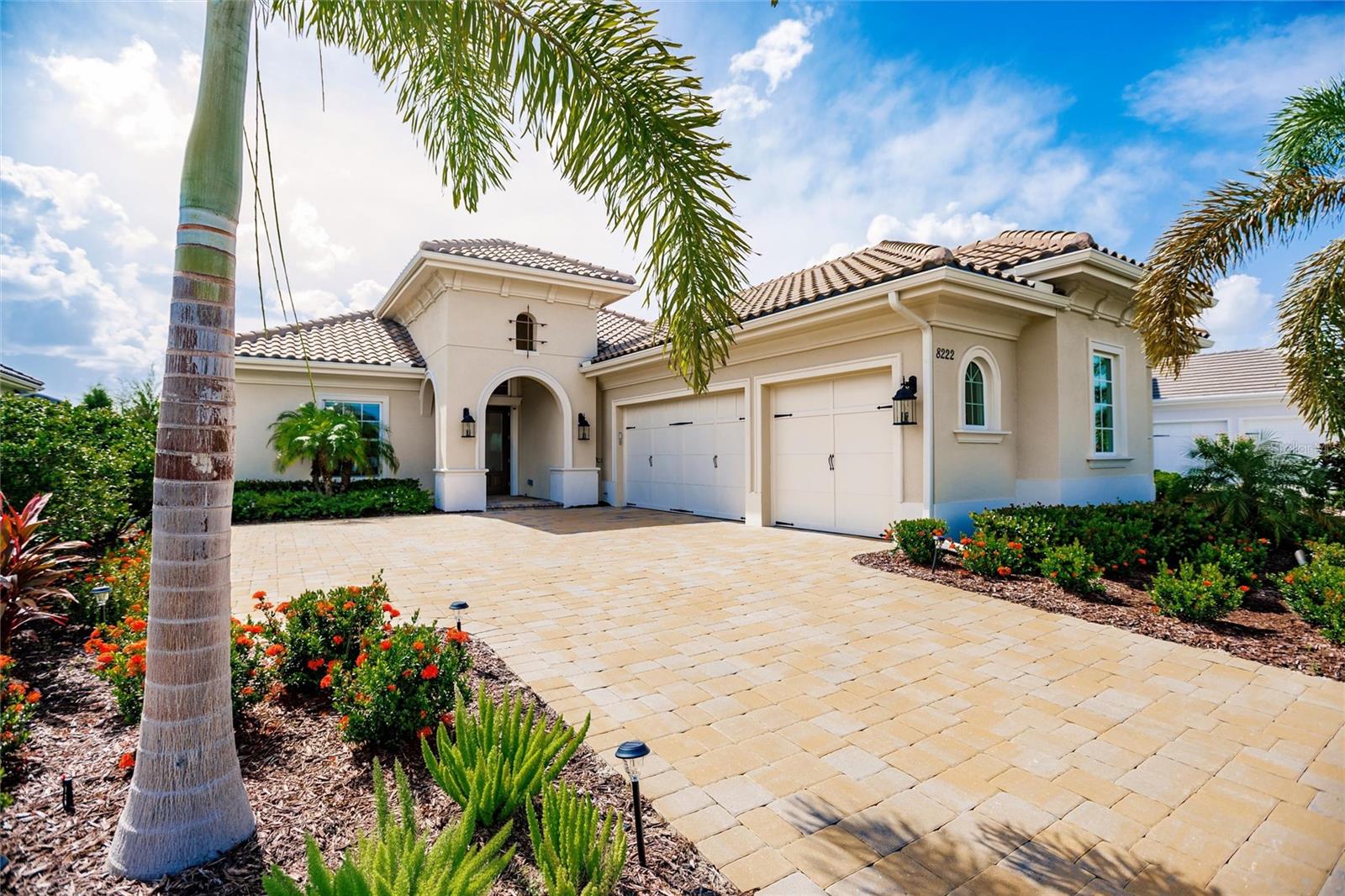 Discover unparalleled elegance in this stunning Cambria III model by Stock Homes, built in 2023. Nestled in the prestigious Lake Club gated community, this meticulously crafted home offers a harmonious blend of luxury and comfort with 2,638 Sq. ft. under air and 4,012 sq. ft. of total exquisite living space. This Cambria model has many extras not found in similar models. HIGHLIGHTS INCLUDE: Open Floor Plan, perfect for modern living and entertaining. Great Room boasts a grand 13ft tray ceiling with 7¼” cove crown molding. A Kitchen to die for, with beautiful quartz countertops, top-of-the-line stainless steel appliances, spacious pantry, and cabinets with pull-out drawers and two lazy Susan's. The spacious den, ideal for a home office or study, has double French doors with plenty of natural light. The Master Bedroom is a private retreat with a large tray ceiling accentuated by crown molding, two walk-in custom-built closets, and French doors leading to the lanai. The Master Bath features an oversized luxurious soaking tub and a walk-in shower. Two guest rooms enjoy their own wing of the house, one of them is an en suite with its own full bath and walk in closet. Step through towering 10 ft glass sliders to a lanai with a large heated pool and spa, summer kitchen, electric fireplace, and enormous ceiling fan that cools the entire area. The Summer Kitchen is fully equipped with a gas grill, sink, and refrigerator, perfect for alfresco dining. Take in sweeping views of your private oasis on a preserve, through massive panoramic picture-window screens. The yard has upgraded landscaping and irrigation system. All doors, sliders and windows are impact, and the sliders are doubly protected by motorized hurricane storm and shade screens. Three car garage with electric car outlet. Many other extras, including motorized Hunter Douglas window treatments. Must See home! Priced right to sell quickly. Furnishings are negotiable - can be a turn-key prized purchase for you. Won't be on the market long. Schedule your private tour today!