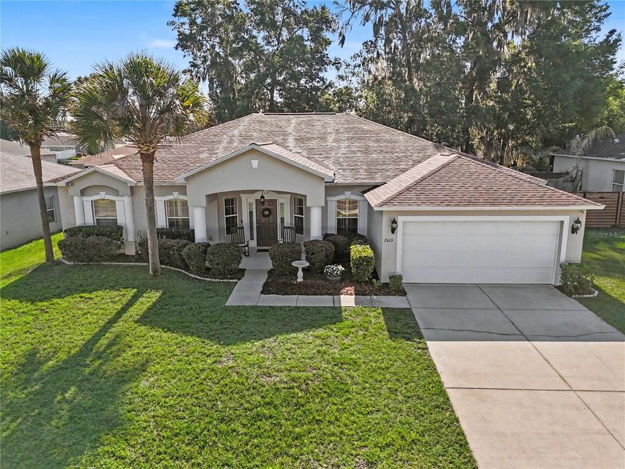 This 4-bedroom, 2-bath split-plan home with den includes 2,239 sq ft of living space on a .23-acre city lot with no HOA. Real hardwood floors run through the living room and primary bedroom; tile in the kitchen, bathrooms, and laundry room. The kitchen features granite countertops with backsplash, a spacious pantry, eat-in dining space, and new Samsung appliances installed in 2023. Indoor Laundry room with Samsung washer and dryer that convey. The 2-car garage adds practical storage and parking. A screened lanai with a recently remodeled ceiling opens to a fully fenced yard enclosed by a new 2025 white vinyl fence, surrounded by fresh landscaping. Major systems are updated: roof replaced 2023, AC replaced 2022. All city utilities — electric, water, sewer, and trash. AdventHealth Ocala and HCA Florida Ocala Hospital both approx. 3.5 mi. Walmart Supercenter approx. 1.5 mi. Chelsea Coffee Co. approx. 1.4 mi. Downtown Ocala approx. 3 mi. Interactive 3D Matterport walkthrough with floor plan available.