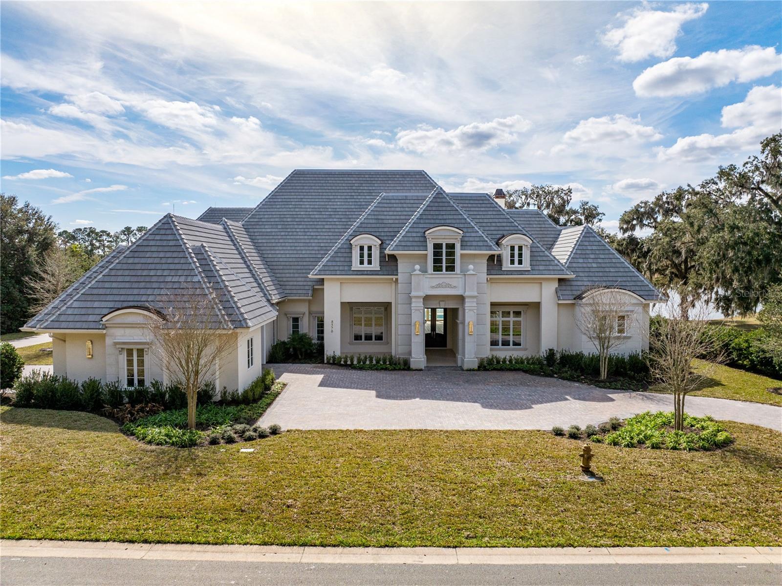 Indulge in luxury living from this impeccable new construction estate by Equestrian Luxury Homes. The award-winning Roberts Design Group, a premier design firm with awards in superior design and luxury categories, tastefully designed this extraordinary home, checking off all the bells and whistles.
Prepare to be impressed as you enter through the foyer with a custom marble design that leads you to the open kitchen adjacent to the living room area and extends to the outdoor living space. The main living area features 18' high ceilings, multilayered crown molding, and baseboards.
This home is a true sanctuary, offering a blend of luxury, comfort, and technology. Don't let this opportunity pass you by!