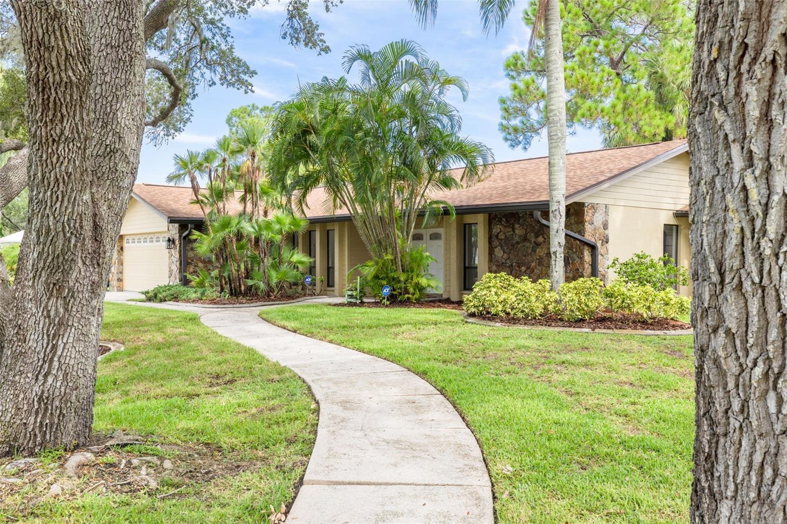 Indulge in the beachside lifestyle at this showstopper of a home that offers exclusive access to Pasco County’s only private Gulf beach, plus a residents-only pool, tennis courts, boat launch and optional membership to the Yacht Club and boat slips to rent as available! The home has been completely renovated, leaving no trace of last year’s hurricanes! Located on a lushly-landscaped corner lot, this home features a chef’s dream Kitchen with brand new stainless Frigidaire Gallery appliances, a center island cooktop and a hood that vents to the outside! Granite counters flow to a Breakfast Bar and adjacent Breakfast Area and Family Room that overlooks the stunning wood-burning Flagstone Fireplace and hearth, with a view through the French doors to the sunlit screened Lanai! The formal Dining Room welcomes family and friends, with plenty of room for a large table for special get-togethers! The large Entry Foyer opens to a spacious formal Living Room. The primary Ensuite features elegant French doors to the screened Lanai, brand new vanity with dual sinks, a separate updated shower/commode, plus a cedar-lined Walk-in Closet and an additional built-in Closet! Each of the two guest Bedrooms has its own brand new vanity and commode, with a shared Shower/Tub in the center for maximum privacy! The well-sized Laundry Room features new overhead cabinets, vanity and stainless steel sink, with hook-ups ready for a washer and dryer! The water heater is brand new, and the electrical panel was replaced in 2019! AC was installed in 2021. Roof was new in 2014. The hurricane-proof Garage door provides added security! This gem of a home is just minutes from the vibrant riverfront city of New Port Richey, with restaurants, breweries, coffee shops, bakeries, and year-round fairs and festivals! Less than 30 minutes to Tampa International Airport!