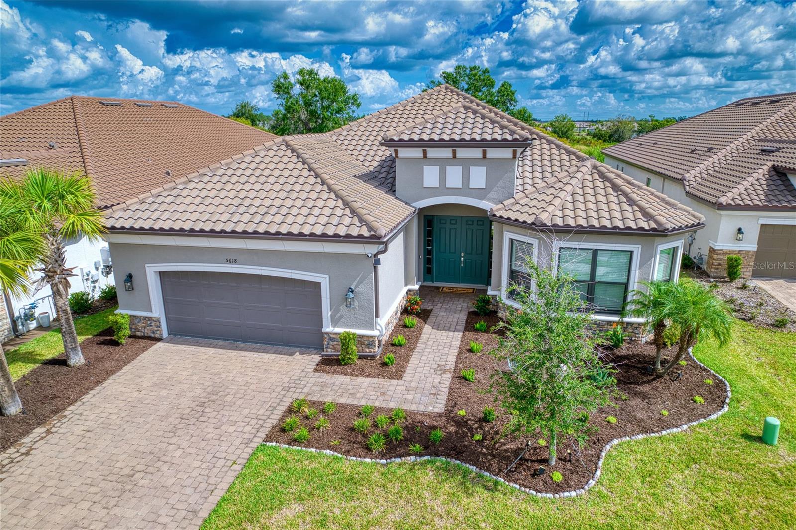 INTRODUCING this gorgeous move-in ready 3,000+ Sq Ft Pallazio in the community of Esplanade at Artisan Lakes. This spaciously designed home boasts 3 bedrooms, 3 full bathrooms, an office/flex rm, massive kitchen, upgraded Monogram professional grade appliances, 8' doors, upstaged structural design, 4' extended garage, high-end ceiling fans throughout, plus it is only 2 years old. This premium lot has conservation privacy to the rear and sits on a cul-de-sac street. As you walk through the grand double door front entry you will experience that 'wow' feel of the open floor plan with the tall ceilings and abundance of natural lighting. Each room has been enhanced with upscaled ceiling fans. The appliances, including the washer and dryer, have 4 more years under warranty. Designer closet system in the master that can be reworked to meet your needs at no cost. Entry way through the kitchen electric has been upgraded with Legrand Adorne light switches and plugs. The Whole house water softener has a warranty valid until April 2028. The bar is highlighted by a 100 bottle Dual-Temp wine and beverage refrigerator. The two sliders lead to the massive covered /screened lanai which has been plumbed for an outdoor kitchen as well as a fireplace, if desired. Note that there is Plenty of room to put in your own private pool... the Seller has renderings of those displayed. The beautiful Polyaspartic pro grade floor sets off the garage which includes 4' extended depth as well as overhead storage. The Polyaspartic flooring was used in the lanai also and looks top-notch! Artisan Lakes is a natural gas community with minimal owner maintenance required for your convenience. Come and be a part of it all...from the option to enjoy a high variety of social and fitness activities to choose from to the concept of optimal location to I-75 and I-275 so you can access endless shopping, restaurants and entertainment!