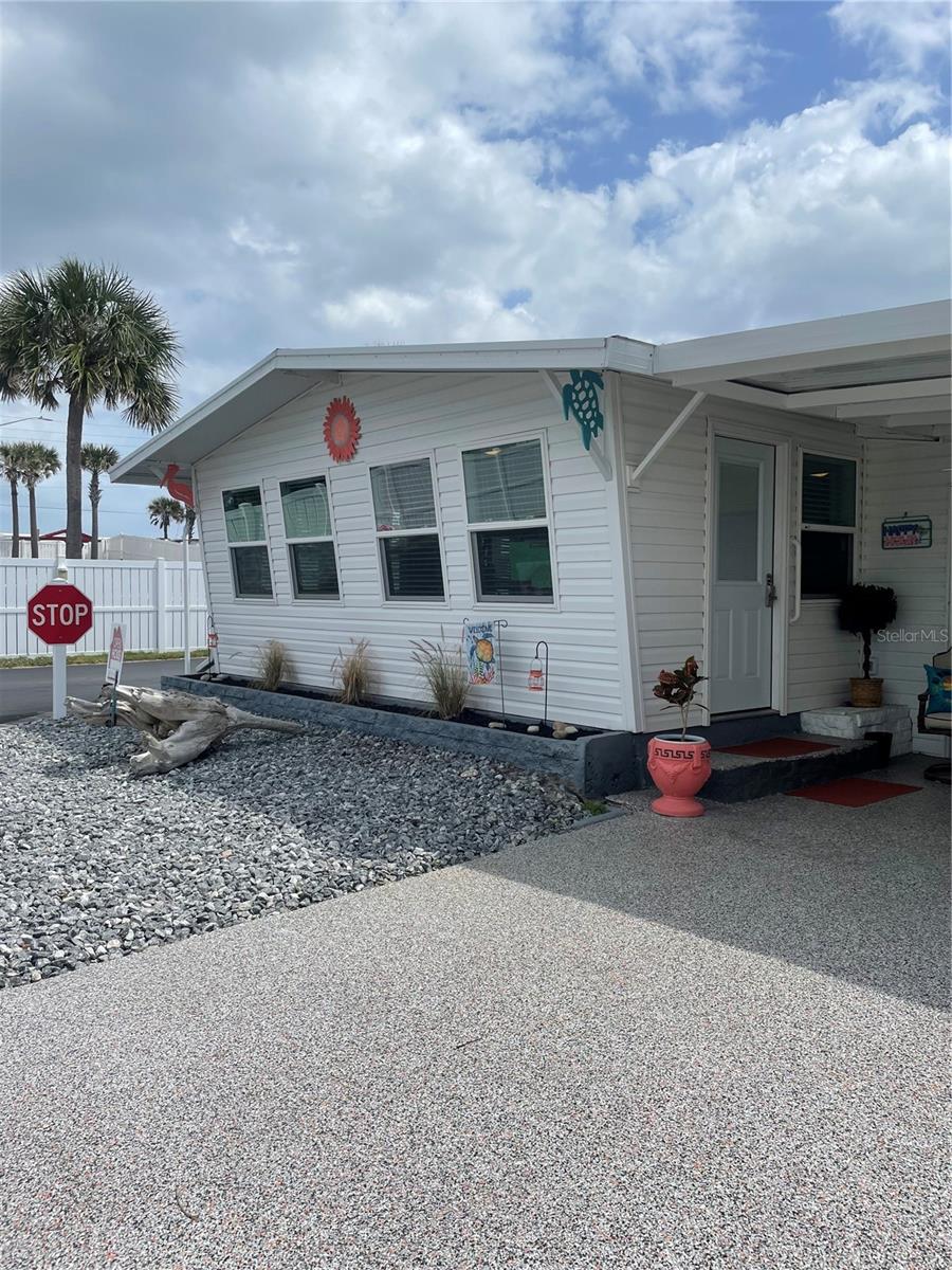Have you dreamed of living beachside? Thought it was unaffordable? Live the dream of owning beachside in this two bedroom, two bath home. It has been updated to an open floor plan with a Great Room, Dining Room and a Kitchen that has all new cabinets with granite (yes granite!) counter tops; the french door refrigerator, oven, and dishwasher is less than 2 years old, the stove top and hot water heater is less than a year old. There is engineered flooring throughout for easy beach living! Enjoy you morning coffee in the Florida room before walking or riding over to the beach or to the Intracoastal to fish.
Surfside Estates is a resident owned co-op community, located along the Intracoastal Waterway, just across the street from the beach and where you own your lot-share and never pay rent. The community has a low maintenance fee of $180 each month that includes cable TV, high-speed internet, lawn service, heated saltwater pool, two fishing piers and clubhouse. The clubhouse has a kitchen, pool tables, TV, library, fitness center and shuffleboard. Along the Intracoastal, you will find a screened gazebo, fire pit, barbecue, benches, horseshoe pits, the two partially covered fishing piers, kayak racks and launch. With an active Social Club, you can choose from yoga, pool aerobics, an ice cream social, Bingo, pool teams, card tournaments, karaoke, dances, community breakfasts, potluck dinners, and so much more! Or take a walk, ride your bicycle, drive your golf cart around the friendly neighborhood. Either way, there seems to be something for everyone.