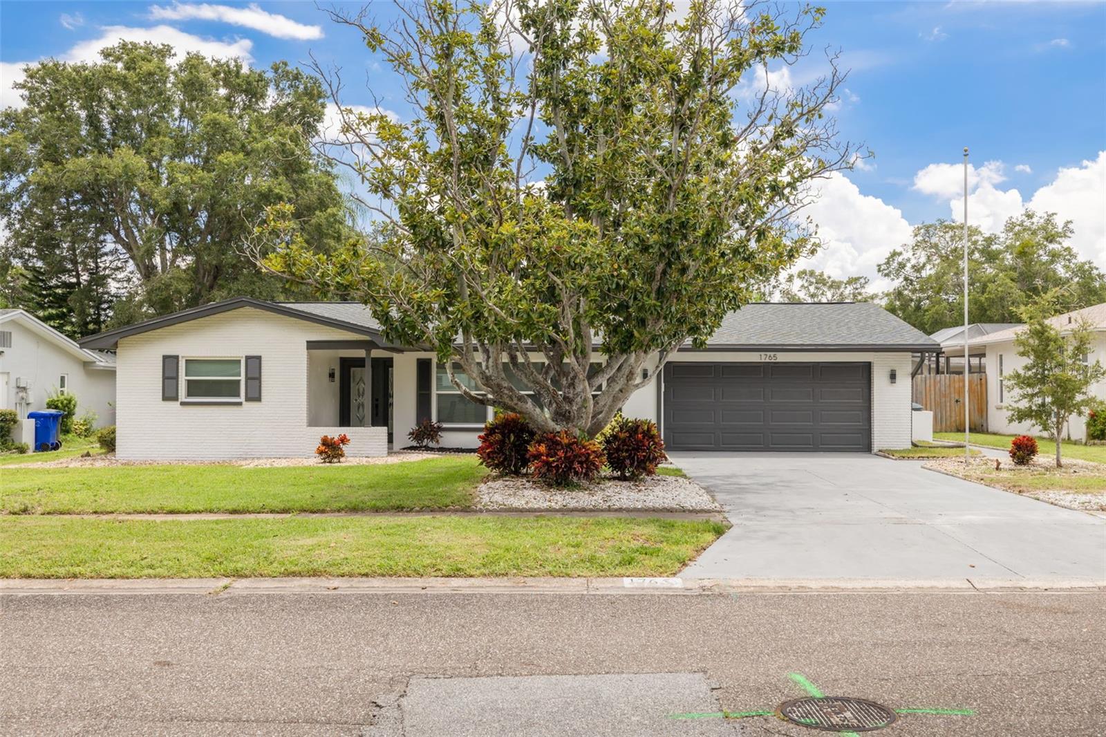 Don't miss out on this fabulous, REMODELED 3 beds, 2 full baths, POOL house in the highly desirable Ranchwood Estates subdivision. The house is situated in a prime location only few mins away from downtown Dunedin and close to all shopping, and restaurants. You will love this charming neighborhood, open floor plan and many upgrades including a master suite, and custom designed wood kitchen! Improvements include luxury vinyl flooring, modern porcelain tile through the house, newer AC system, new roof, fresh interior knock down texture, interior/exterior paint, impact windows, upgraded LED recessed lighting, new ceiling fans, new 5' baseboards, brand new interior doors, and many more features. The brand new customized, hardwood kitchen is designed to provide plenty of storage, has soft close drawers and cabinets, new porcelain tile floor, luxury countertops with waterfall design, brand new Samsung stainless steel appliances with breakfast bar seating. The bathrooms are TOTALLY renovated with new vanity tops, porcelain tiles, and shower stalls with modern accessories. The master suite boasts a sumptuous soaking tub for ultimate relaxation, double sink vanity, while a walk-in shower adds to the sense of indulgence. This house is REMODELED from top to bottom and designed to entertain with open floor plan. DETAILS MATTER, and meticulous craftsmanship is evident at every turn. Step outside where a HUGE backyard oasis awaits for family fun and gatherings. The in-ground pool and recent mature landscaping seamlessly blends with the elegant interior. It provides great curb appeal, low maintenance landscaping and mature grass. The house is centrally located, less than 1 mile drive to Countryside Mall, shopping plazas, restaurants, and less than 10 min drive from downtown Dunedin. Proudly standing in a non-flood zone, this home promises peace of mind. A rare find, encapsulating comfort, convenience, and sheer sophistication, this residence invites you to live in the lap of luxury. Welcome home!