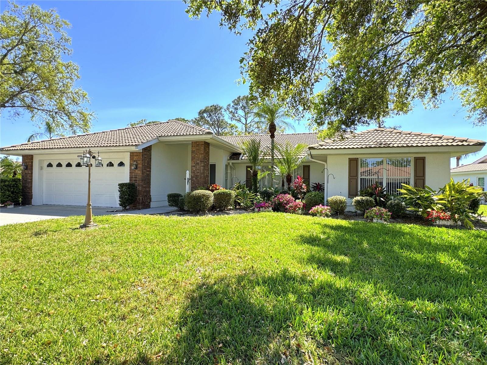 Welcome to everyday vacation living in this well-maintained, lovely home in the desirable gated community of Garden Lakes! Amidst beautiful shade trees and tropical landscaping, this inviting residence offers a spacious and functional layout you’ll appreciate. It features an eat-in kitchen, large living room, sunny family room, and a roomy dining area—all with a natural flow that’s perfect for entertaining. The home is laid out for privacy and comfort as well as convenience. Imagine the serenity of sipping your favorite drink and reading a good book while relaxing in the large screened lanai and hearing birds chirp as they visit your expansive back yard (one of the largest in the neighborhood)! You’ll also appreciate extra touches in the house such as crown molding and decorative columns that add elegance and style.
Garden Lakes is a vibrant and active 55+ community which offers resort-style amenities, including an updated clubhouse, a giant heated pool, tennis & pickleball courts, shuffleboard, a community library, a fitness center, and scenic shaded walking trails- not to mention a packed social calendar full of planned events and get-togethers. The community is known for its beautiful mature landscaping, winding streets, and reasonable fees, which cover exterior maintenance (except the roof), cable TV, internet, lawn care & landscaping, and trash pickup.
Looking for a great location? Garden Lakes is conveniently situated near Bradenton, Sarasota, and the beautiful Gulf beaches. You'll also find great shopping, dining, and medical facilities just minutes away. Plus, there’s no shortage of activities nearby—golfing, cultural events, and entertainment options abound.
Don’t miss your chance to enjoy the best of Florida living in this cheerful home. Schedule your showing today!