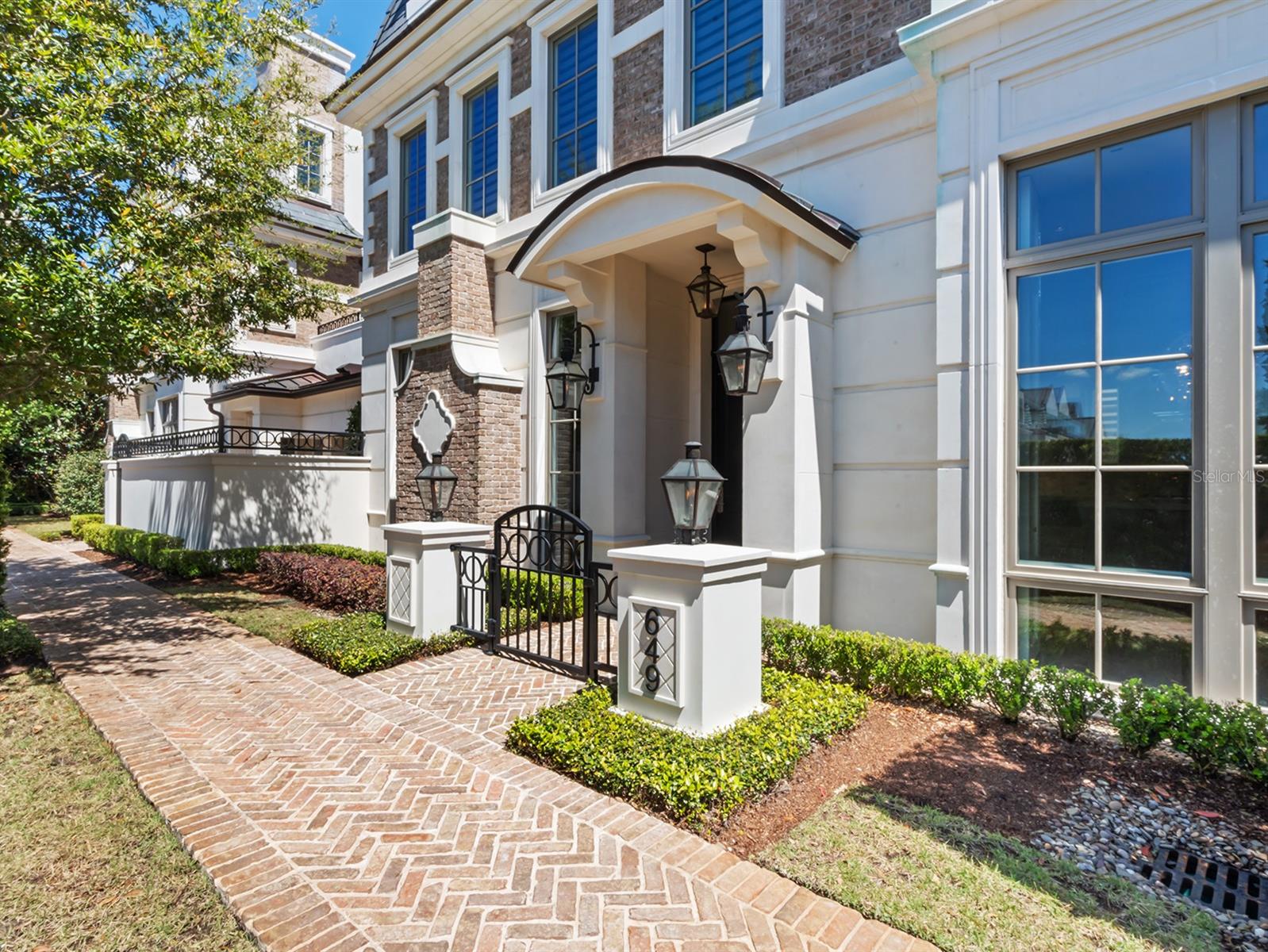 Now offered for lease, this luxury brownstone at northern end of Park Avenue delivers an exceptional lifestyle in the heart of Winter Park. In Park Hill, a distinguished collection of residences, the home is ideally positioned between upscale boutiques, acclaimed dining, cultural landmarks and historic Winter Park Golf Course. As the only brownstones in this prestigious location, this residence offers a rare opportunity to experience refined living in Central Florida. Beyond the brick courtyard and gas lantern-adorned entry, a three-story residence with private elevator unfolds, showcasing classic architecture with contemporary appointments. Soaring 10-foot ceilings, extensive millwork, large windows, hardwood floors and designer finishes create a polished, elevated aesthetic. The main level’s open-concept layout includes a chef’s kitchen appointed with Wolf and Sub-Zero appliances, custom cabinetry, marble surfaces, a central island with bar seating, and a wet bar with beverage refrigerator and ice maker. Seamless indoor-outdoor living is achieved via a private courtyard with summer kitchen and alfresco dining area. Two guest suites with walk-in closets and en-suite baths are found on the second floor, along with a laundry room and a covered terrace featuring a fireplace, wet bar and powder bath, ideal for enjoying sunsets and Winter Park’s mild climate. The third-floor primary suite offers dual custom walk-in closets, a private balcony and a spa-style bath with soaking tub, glass-enclosed shower and dual vanities. Additional highlights include a two-car air-conditioned garage with storage and soundproof concrete floors. Constructed with Old Carolina brick, three-story block, precast trim and a slate mansard roof, the home blends timeless construction with a low-maintenance, lock-and-leave lifestyle. The monthly rent includes all major utilities and services—cable television, electricity, gas, internet, water, sewer, trash collection, pest control and grounds maintenance—offering a seamless and elevated leasing experience. A minimum security deposit of $25,000 is required. This is a distinctive lease opportunity just a short distance from Park Avenue’s vibrant offerings.