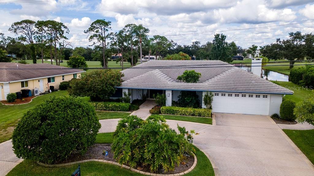 Finally, an updated POOL home in the NON-DEED RESTRICTED desirable Desoto Lakes Country Club is available for the lucky buyer! This is a NON-HOA community as well! This 3 Bed + DEN/ 2.5 Bath/2 Car + Golf Cart Garage home has been stylishly MODERNIZED throughout. Walk up to the expansive covered porch and through the impressive double doors to find a beautiful view of the pool and lush golf course behind. The well-placed dining room just ahead takes advantage of the scenery creating a nice ambiance when entertaining. The kitchen boasts handsome cabinetry, granite countertops, a contemporary hood vent, and high-end appliances as well as a breakfast bar. The spacious living room features a cozy Wood Burning FIREPLACE, vaulted ceilings and a WETBAR. The screened-in lanai showcases TRAVERTINE tile flooring and a built-in wraparound divider that creates distinct covered outdoor living and dining spaces. The HEATED POOL & HOT TUB are the real stars of the show. The sparkling blue water of the pool beckon lazy afternoons in the sun. Afterwards, step into the outdoor, private shower to rinse off. Inside, the primary bedroom features a pool view, a custom walk-in closet, and an en-suite bathroom. Two additional bedrooms are located on the opposite side of the house. For added peace of mind, HURRICANE RATED WINDOWS have been installed and is NOT in a FLOOD ZONE. Membership to the Country Club is NOT MANDATORY. This property also features a well and new pump with a full irrigation system, helping to keep your landscaping lush while lowering the cost of watering. Don’t miss out on this incredible opportunity to own a home that blends comfort, convenience, and value!