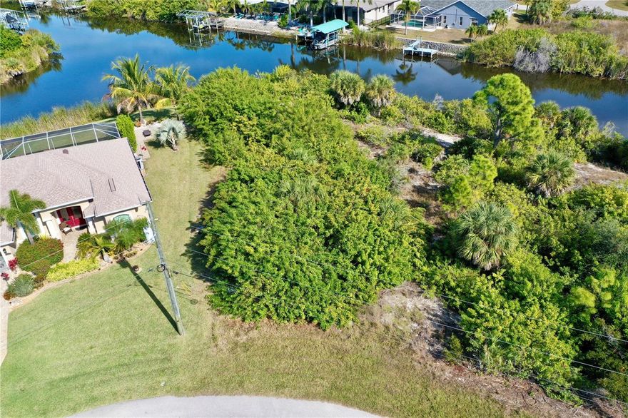 Discover an exceptional opportunity to build your dream waterfront home on this .37-acre (16,316 sq ft) buildable tip lot in the highly sought-after boating community of South Gulf Cove. Perfectly positioned on a sailboat-access canal with direct Gulf access and no bridges, this prime property offers both privacy and breathtaking sunset views thanks to its unique canal orientation. Located at the intersection of the Kansas City Waterway and the wide outer canal, the property enjoys expansive water views and easy navigation through the community lagoon. From your backyard, cruise effortlessly through the lock system into Charlotte Harbor, where the Myakka River and Peace River meet, and continue on to the Gulf of Mexico—a true boater’s paradise. South Gulf Cove offers an array of desirable amenities, including optional HOA membership and an optional Yacht Club, along with PUBLIC WATER and SEWER, a community recreation center, parks, and a public boat ramp. The location is ideal, just a short drive to the pristine beaches of Boca Grande, Englewood Beach, and Manasota Key, as well as nearby shopping, schools, churches, and local attractions. Sports enthusiasts will appreciate being only 15 minutes from the Charlotte Sports Complex, the spring training home of the Tampa Bay Rays and home of the Charlotte Stone Crabs. This is a rare opportunity to secure a premier waterfront lot in one of the area’s most desirable communities.