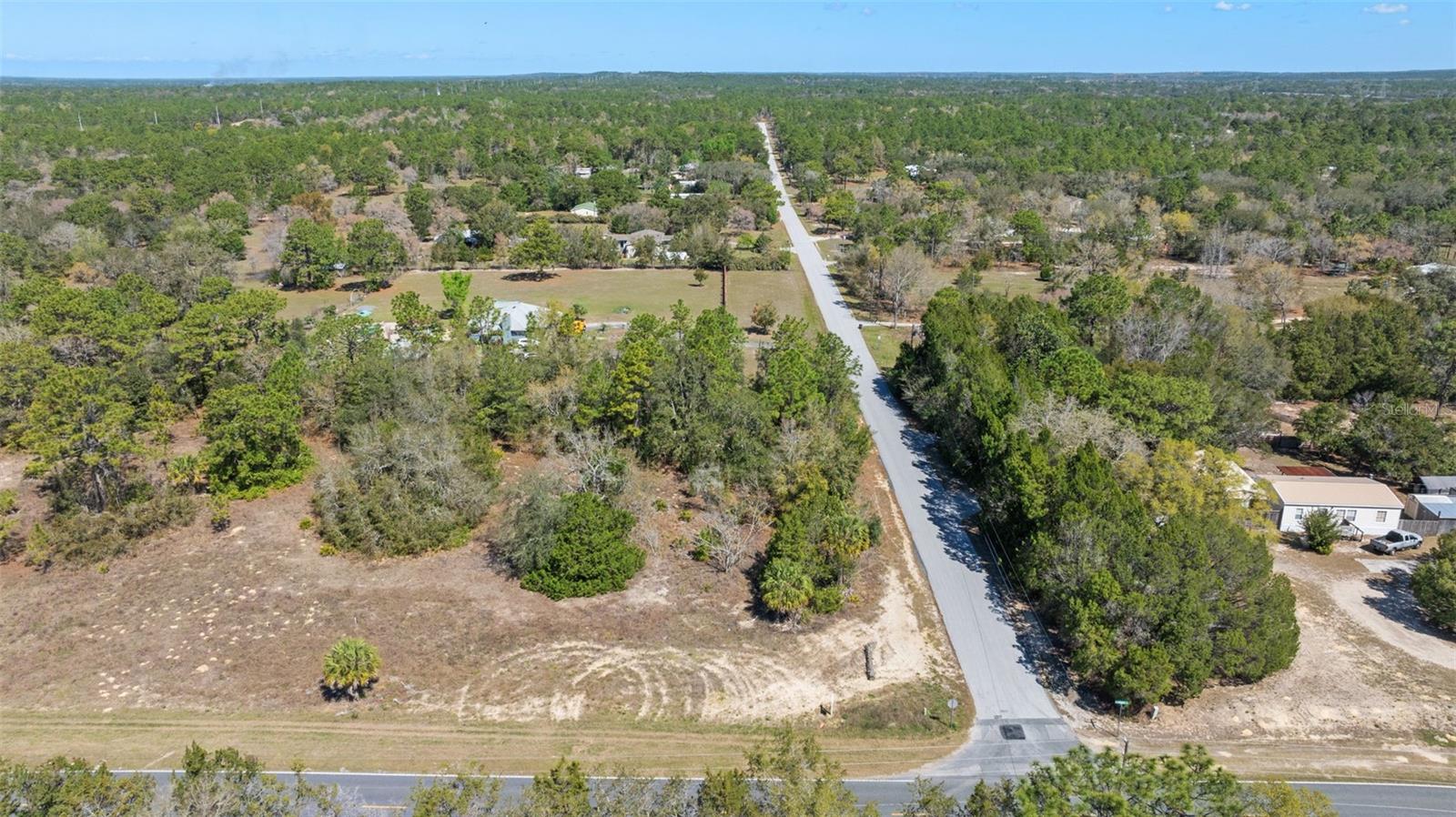 Welcome to your future home site in the serene and inviting Green Acres neighborhood! This vacant lot, situated on a paved road and surrounded by charming homes, offers the perfect blend of community and privacy. Zoned for both mobile homes and single-family residences, it provides the flexibility to create your ideal living space. Conveniently located with easy access to the Suncoast Parkway, you’re just under an hour away from the vibrant city of Tampa. Whether you're dreaming of building a custom home, a vacation getaway, or a smart investment property, this lot provides a fantastic foundation. Plus, it’s located outside of flood zones, ensuring peace of mind. This property comes with essential utilities including septic, public water, and electric, making it ready for immediate development. Don't miss this rare opportunity to own a prime piece of land in Homosassa! Additionally, this lot is one of four adjacent parcels available for purchase, offering an exceptional development opportunity. Explore the potential to create something extraordinary—secure your slice of Green Acres today!